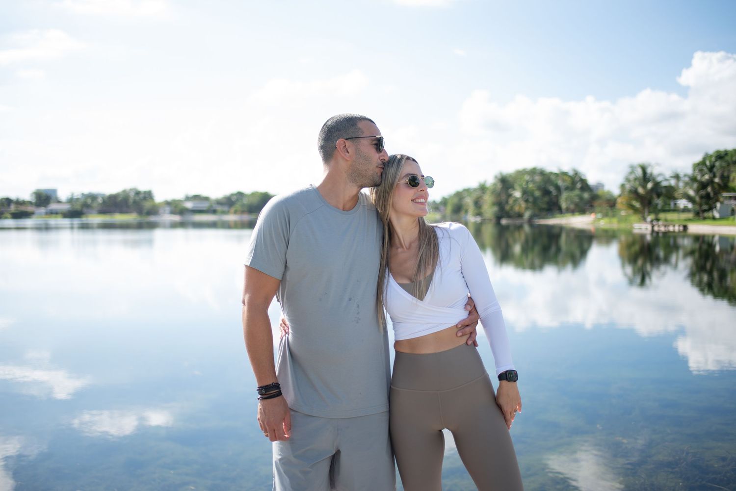 Couple enjoying scenic lake view from wooden dock.