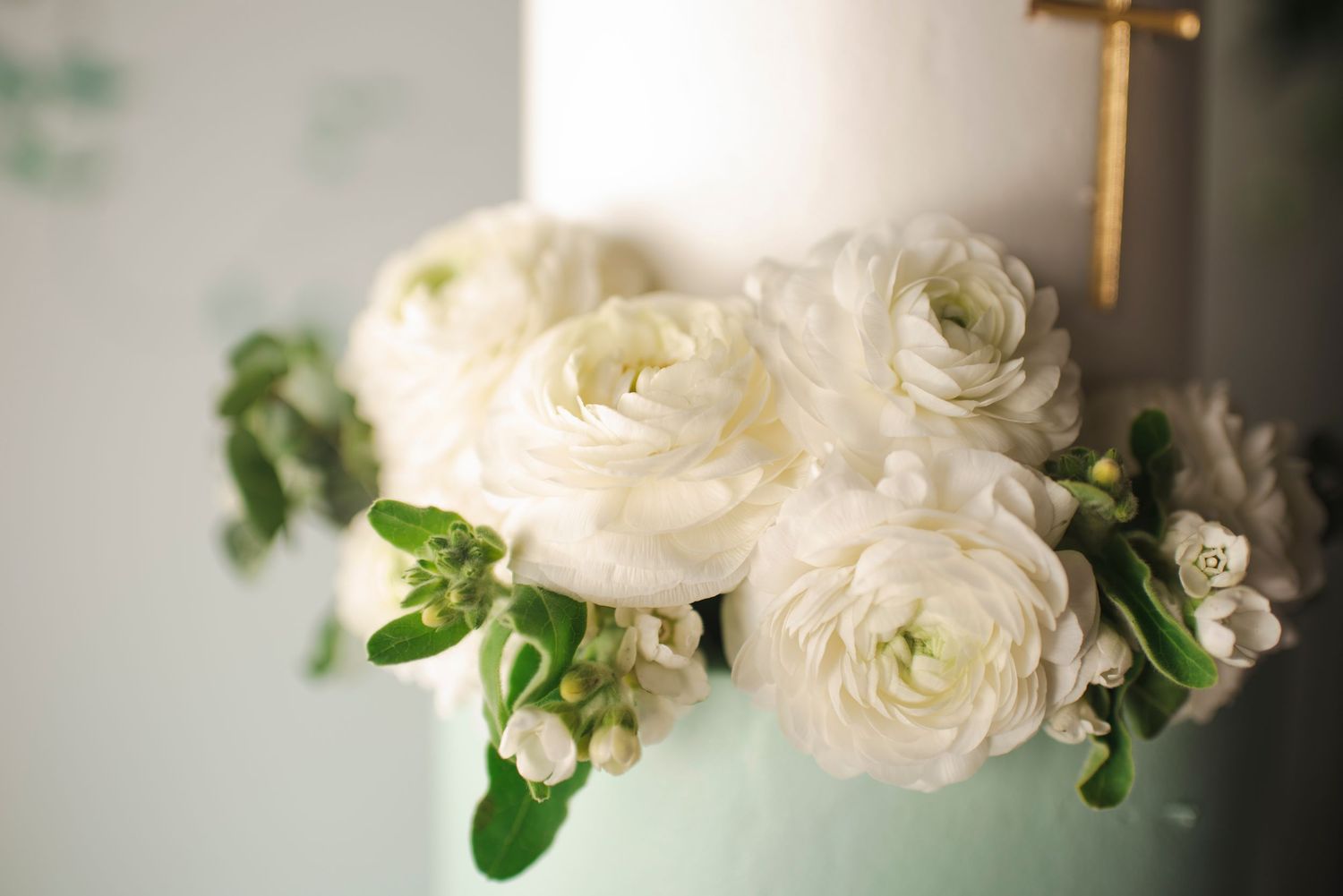 White ranunculus flowers in soft focus create an elegant floral arrangement.