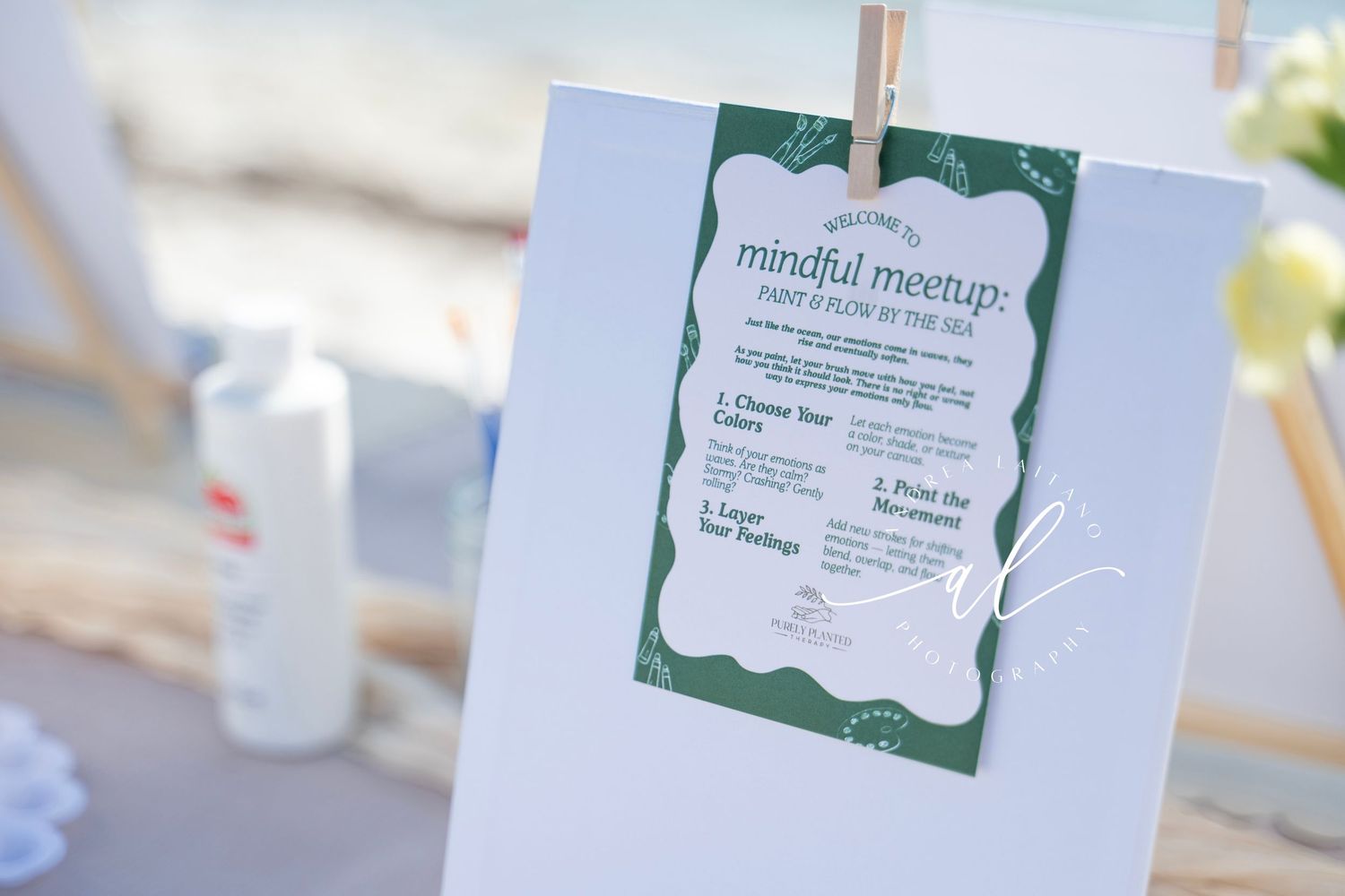 Elegant wedding invitation cards with green borders displayed on a light colored surface at a reception.