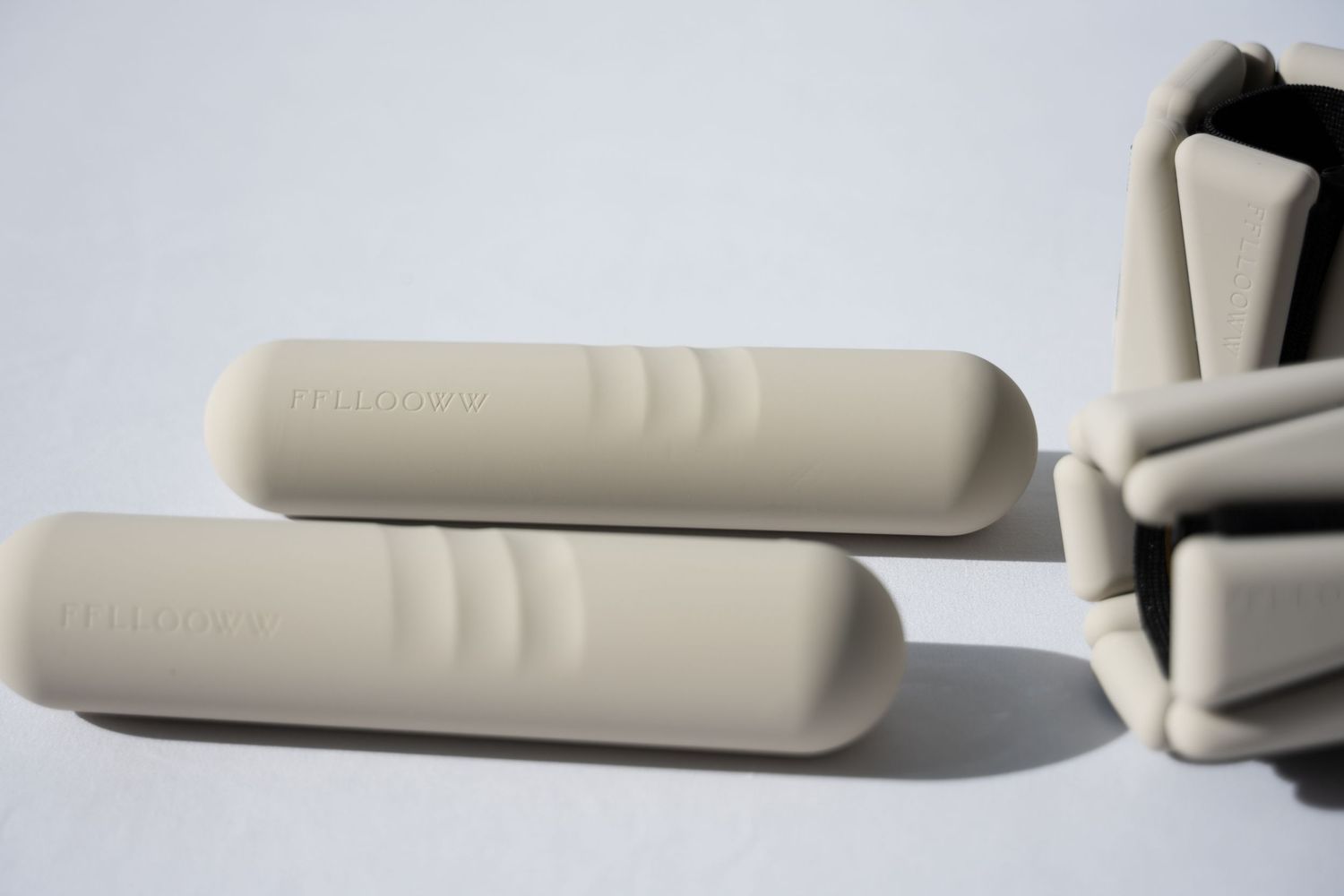 Two beige foam yoga blocks with textured grip lines.