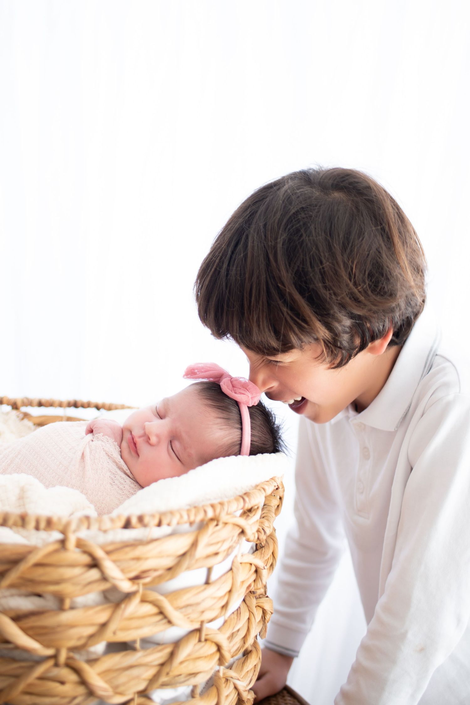 A person in a white shirt leans over to look inside a woven basket in a series of progressive shots.