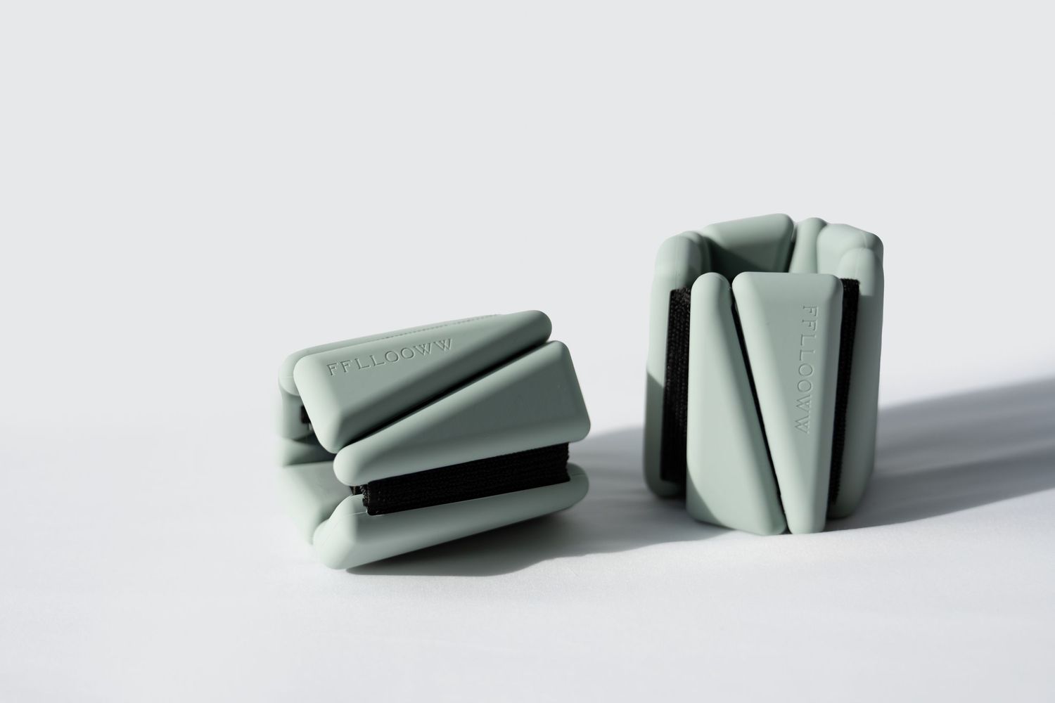 A series of gray ceramic or clay pieces shown in a minimalist progression from whole to broken segments.