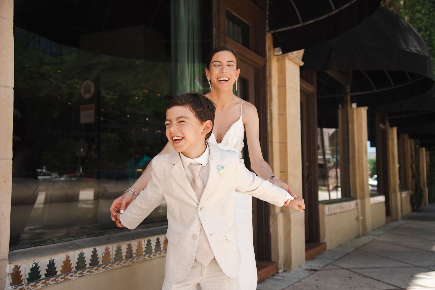 Playful first communion portraits taken under a covered walkway.