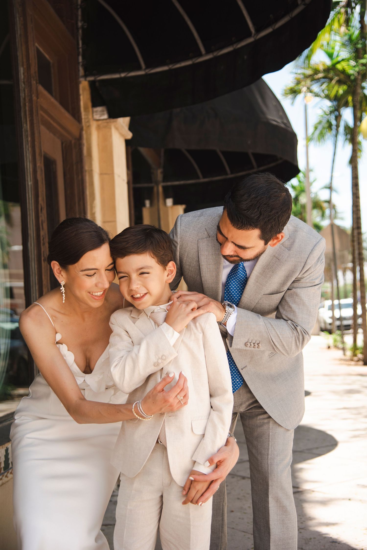 Wedding celebration captured in candid moments under an archway.