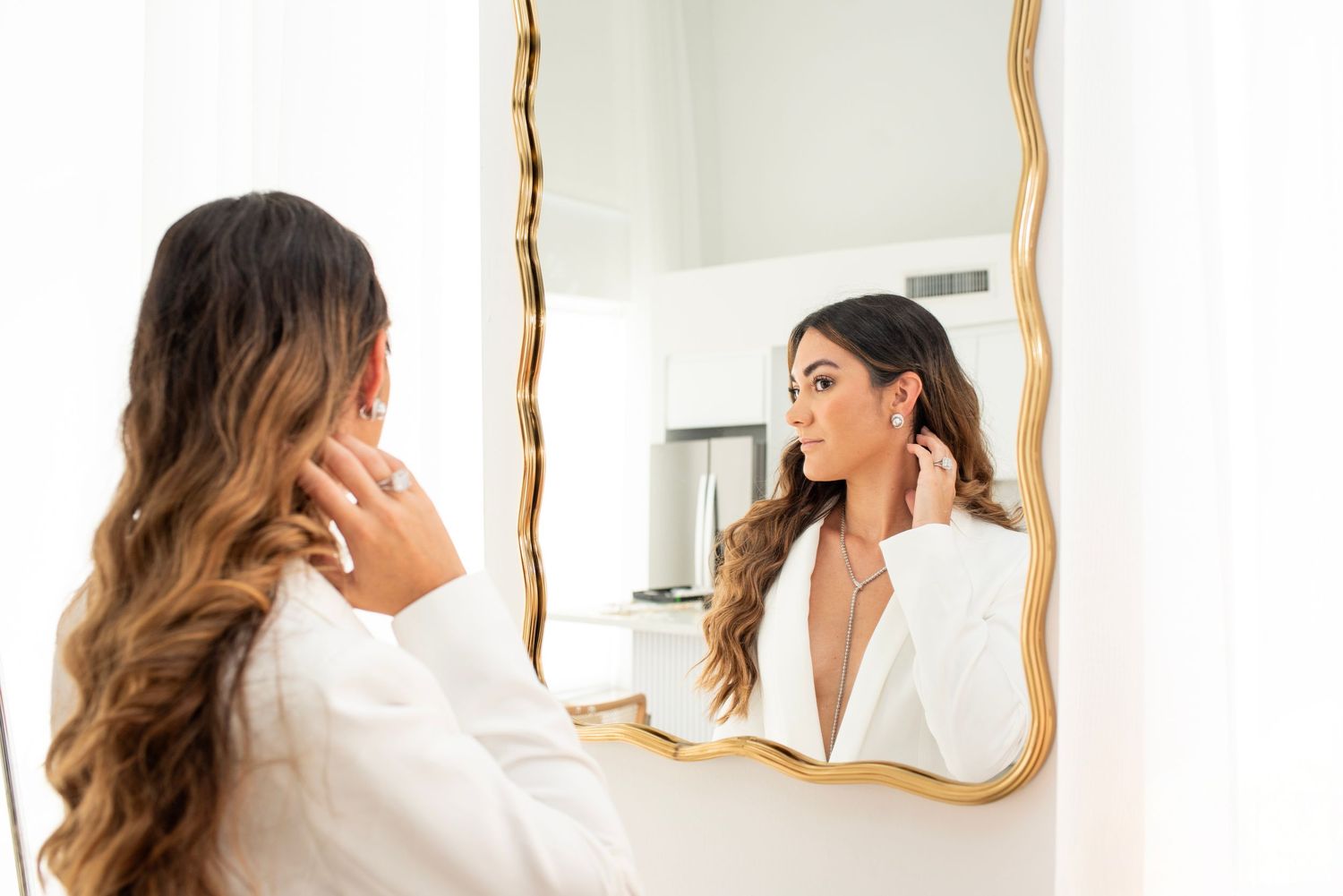 Side view of jewelry styling session in front of vintage mirror.