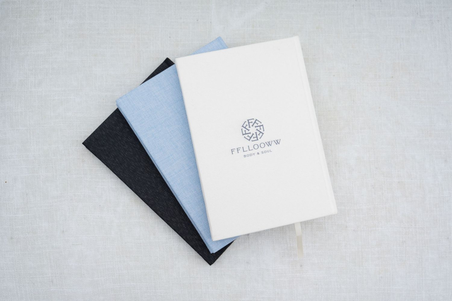 Minimalist white and black business cards displayed on light gray background.