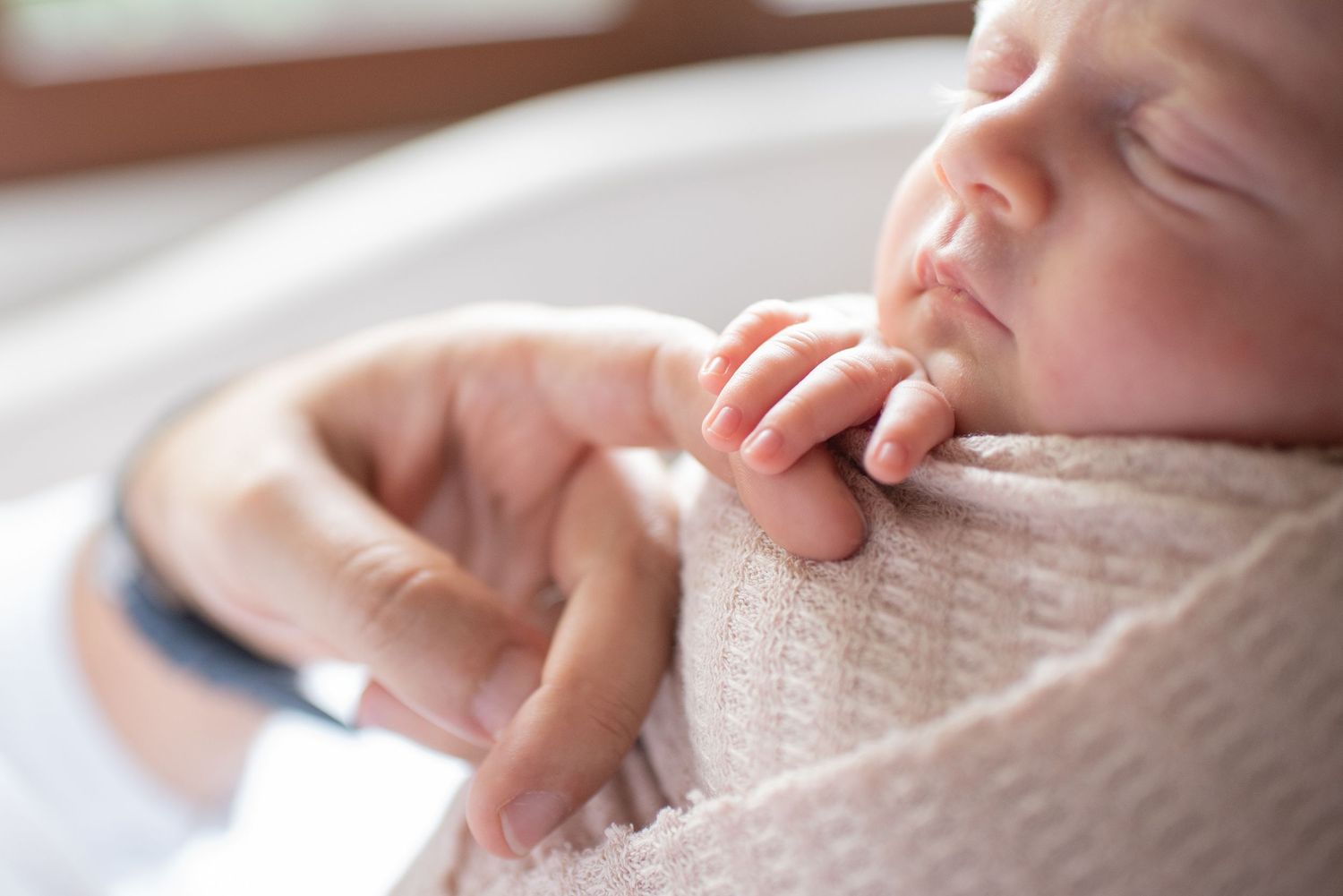 Close-up view of hands gently touching and caressing a soft knit fabric surface.
