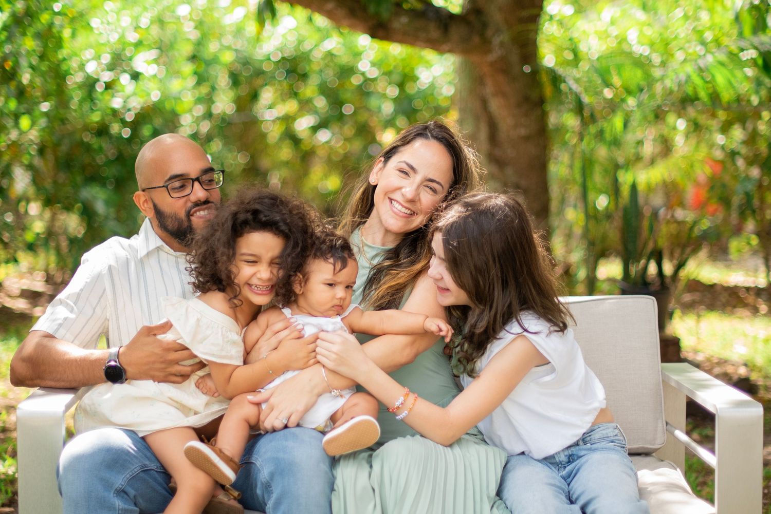 Happy family enjoying quality time together outdoors on a sunny day.