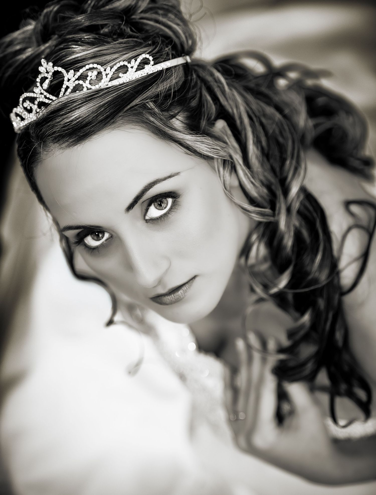 Black and white portrait series showing close-up views of someone wearing a delicate tiara with soft focus and romantic styling.