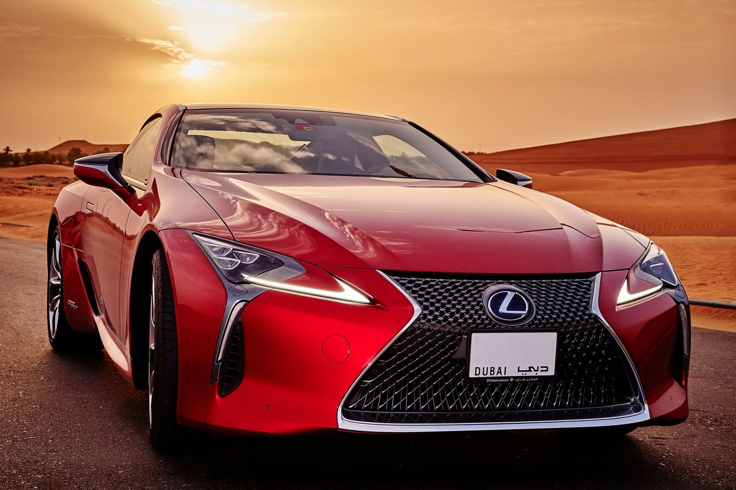 Red Lexus concept car photographed at various angles in desert setting during sunset.