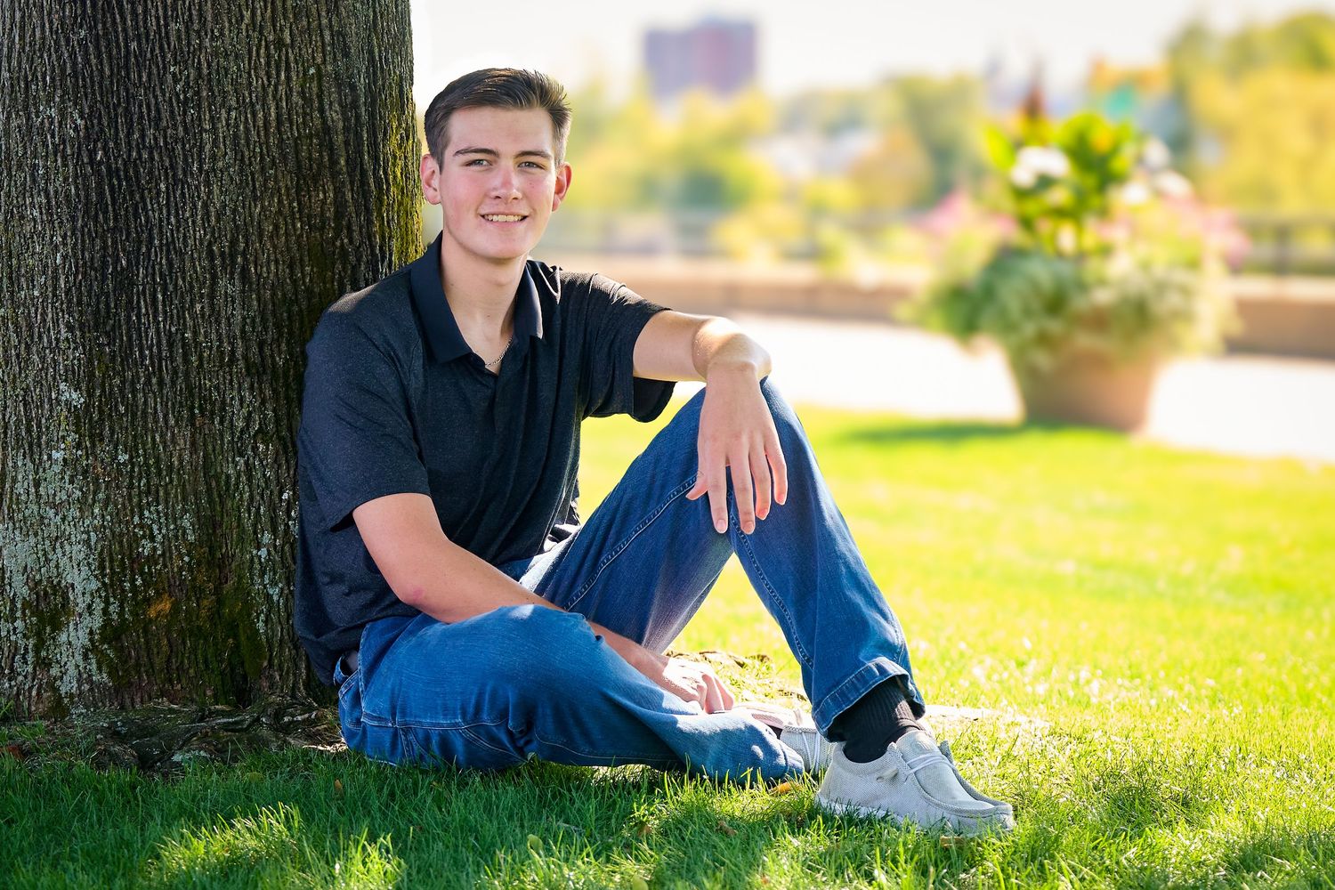 A series of outdoor portraits showing someone sitting on grass in casual attire during a sunny autumn day.