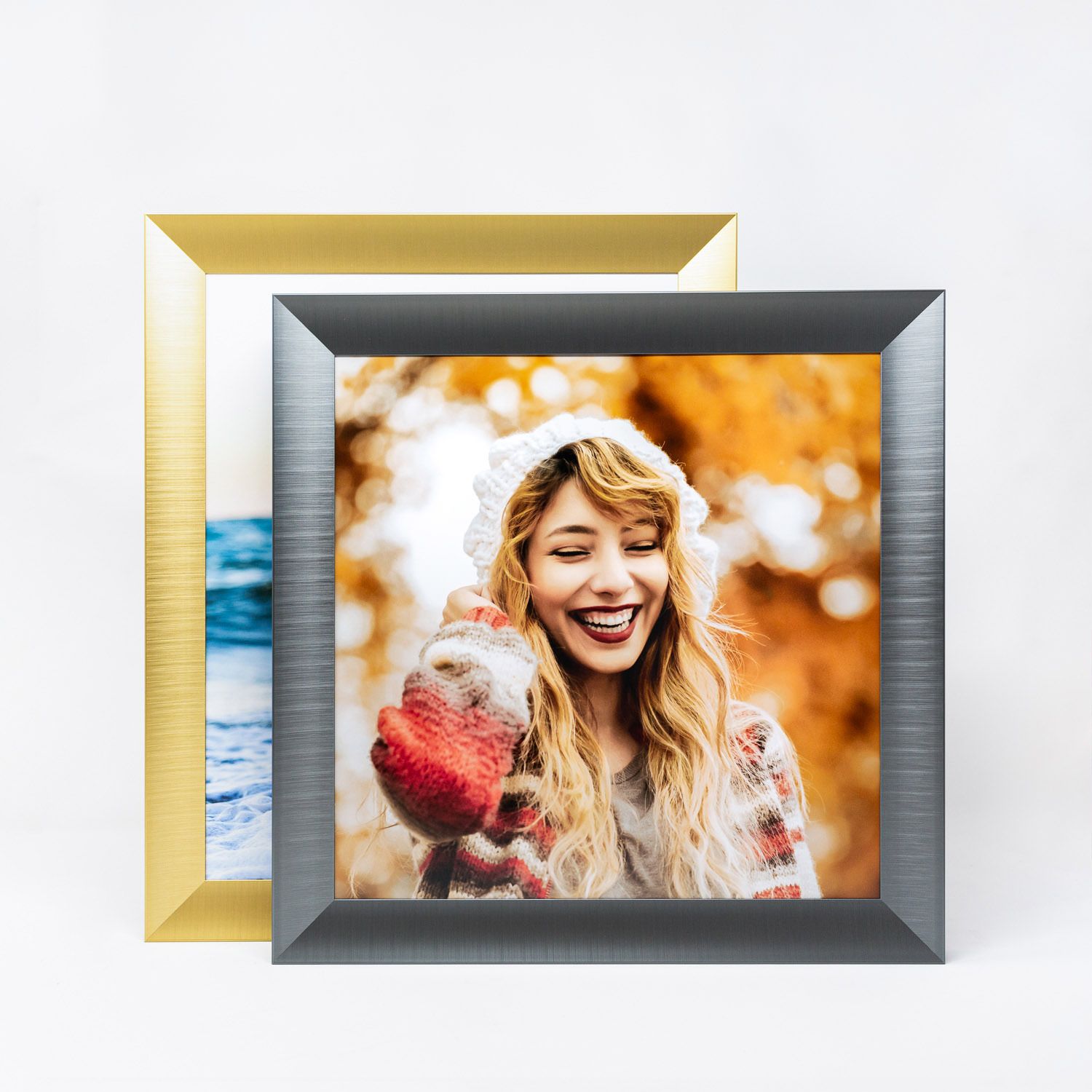 Modern metallic picture frames with gold and silver finishes displayed in a row against white background.