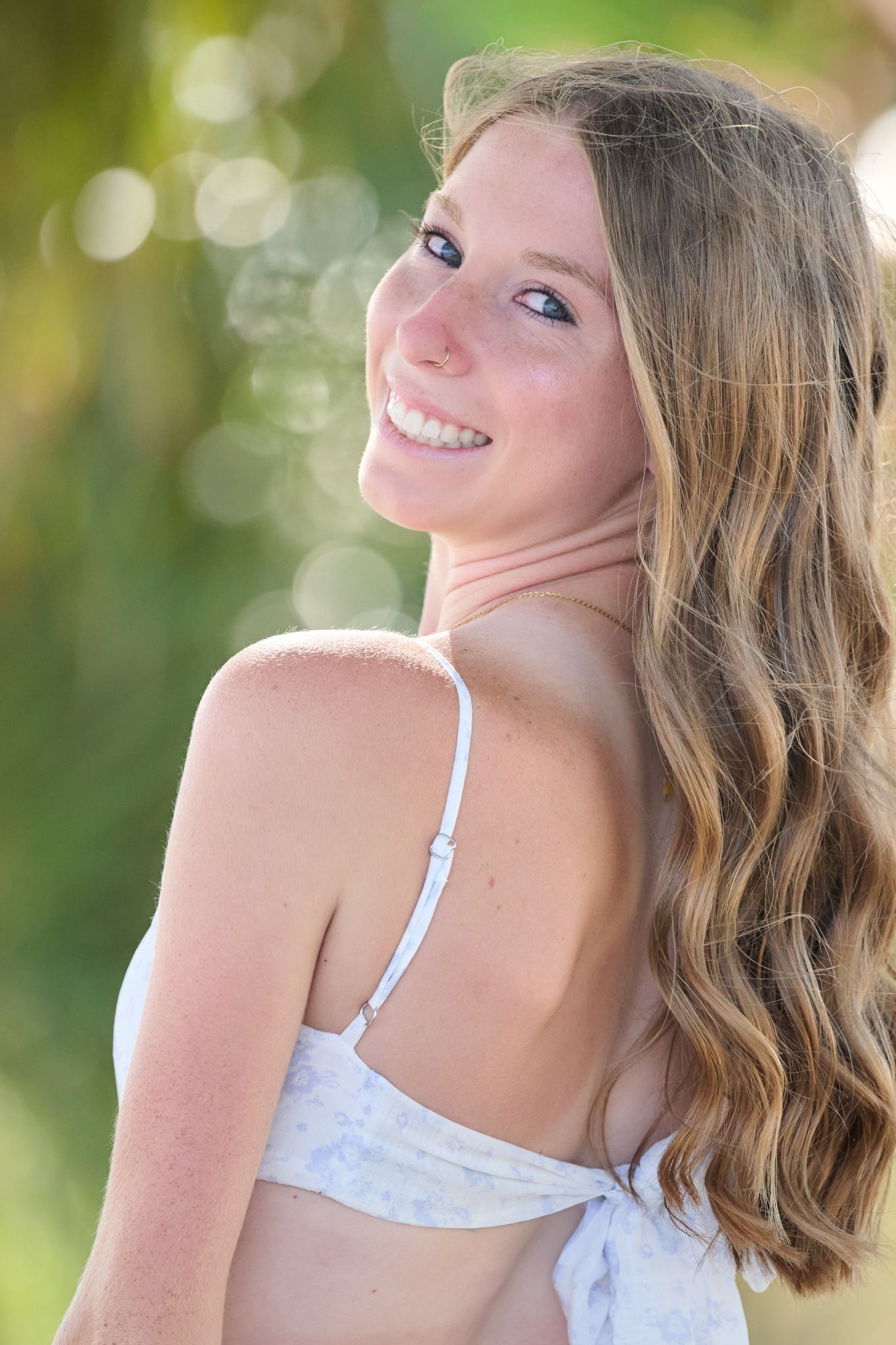 Summer portrait sequence in white top with soft natural lighting and bokeh effect in background.