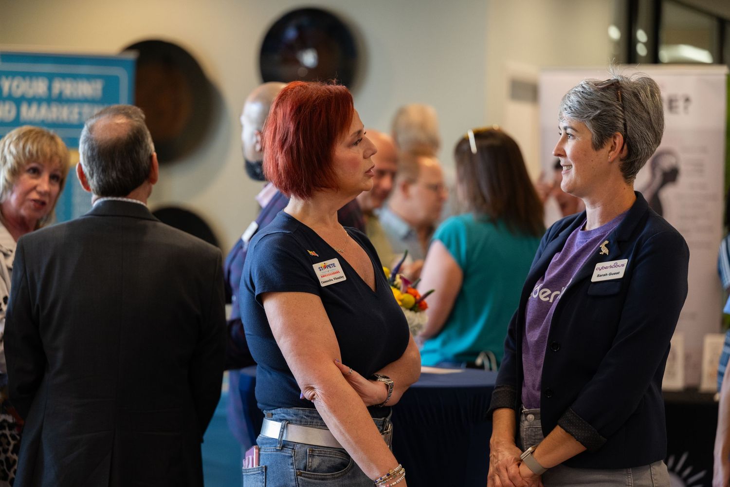 A group of people mingle and network at a professional business event or conference.