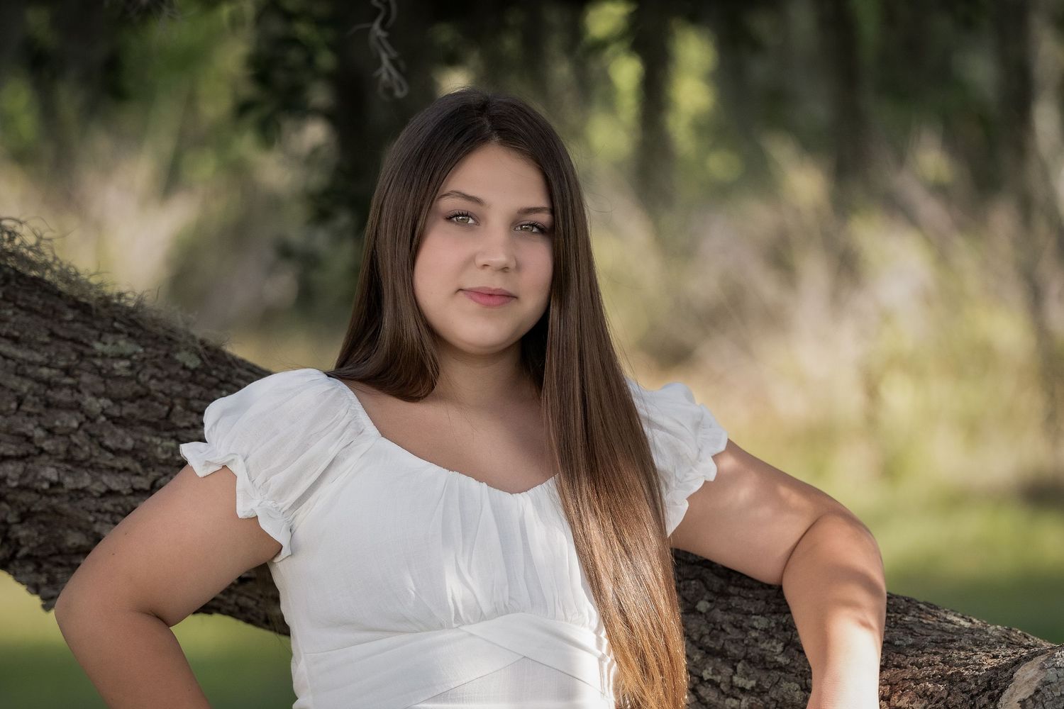Senior portrait photography session outdoors with natural lighting and bokeh effect.