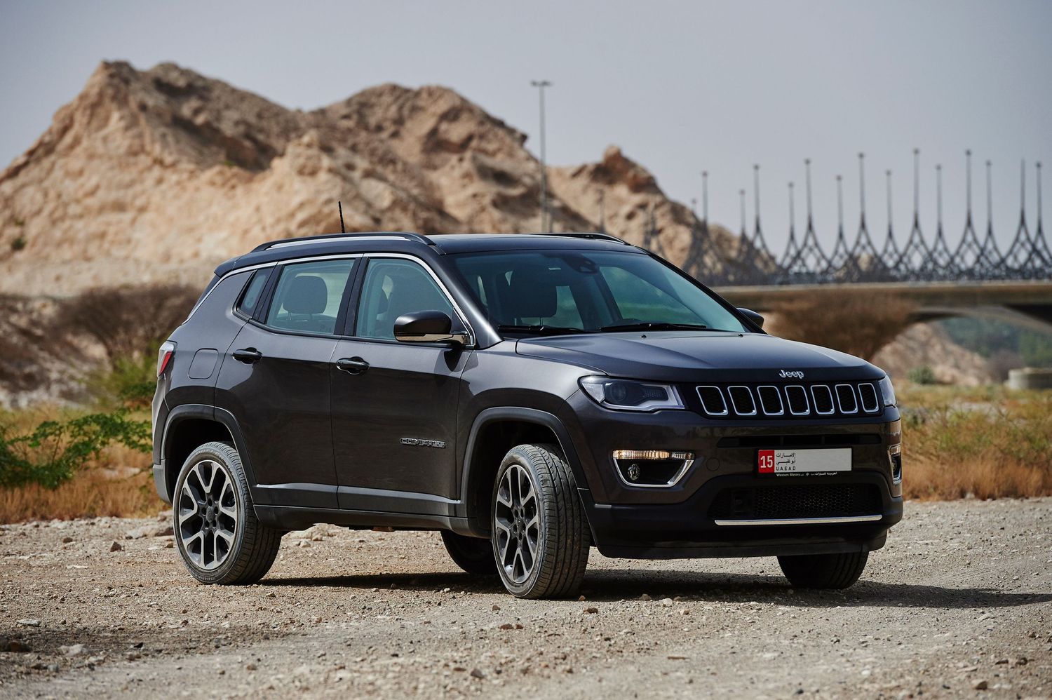 Black Jeep Compass photographed from multiple angles against rocky desert terrain.