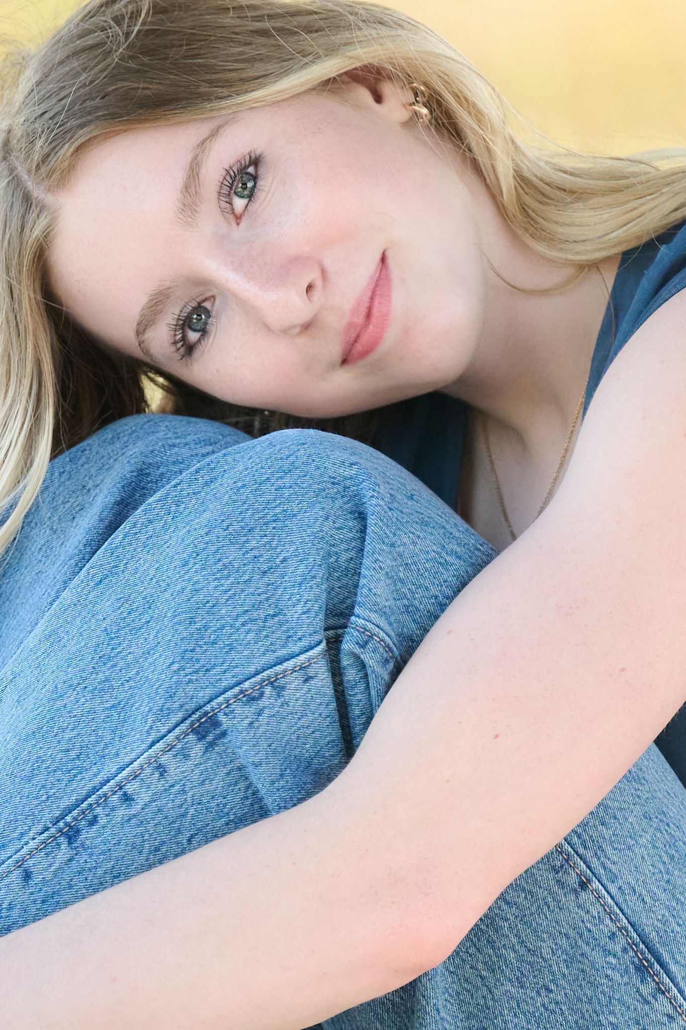 Artistic close-up portrait series with denim jacket against soft natural lighting.
