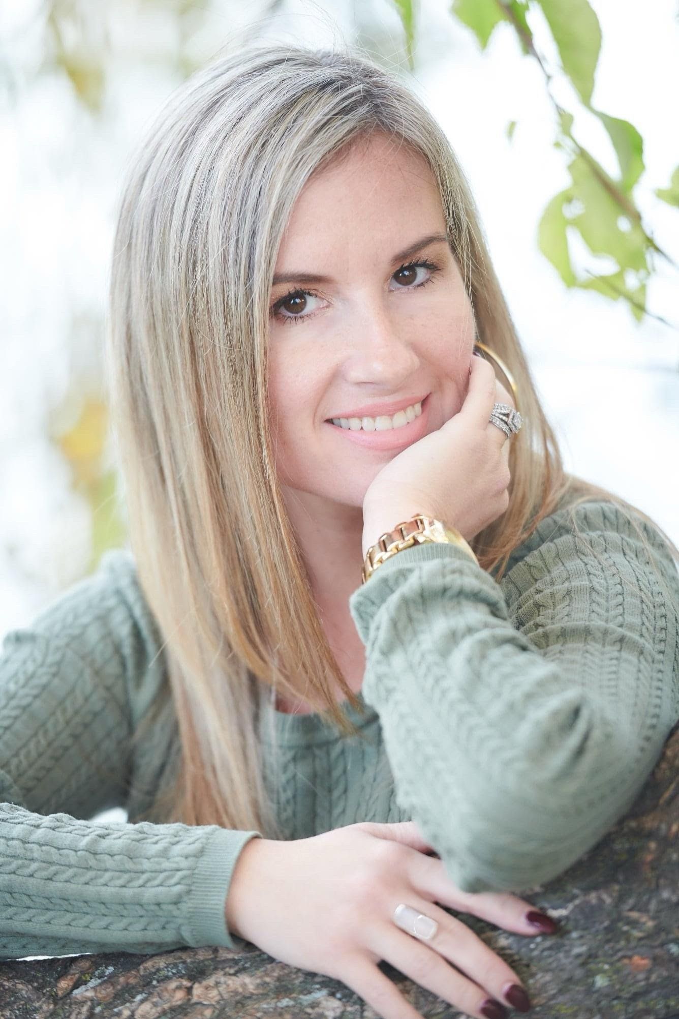 A series of portraits showing someone in a green knit sweater lying on autumn leaves with varying poses and expressions.