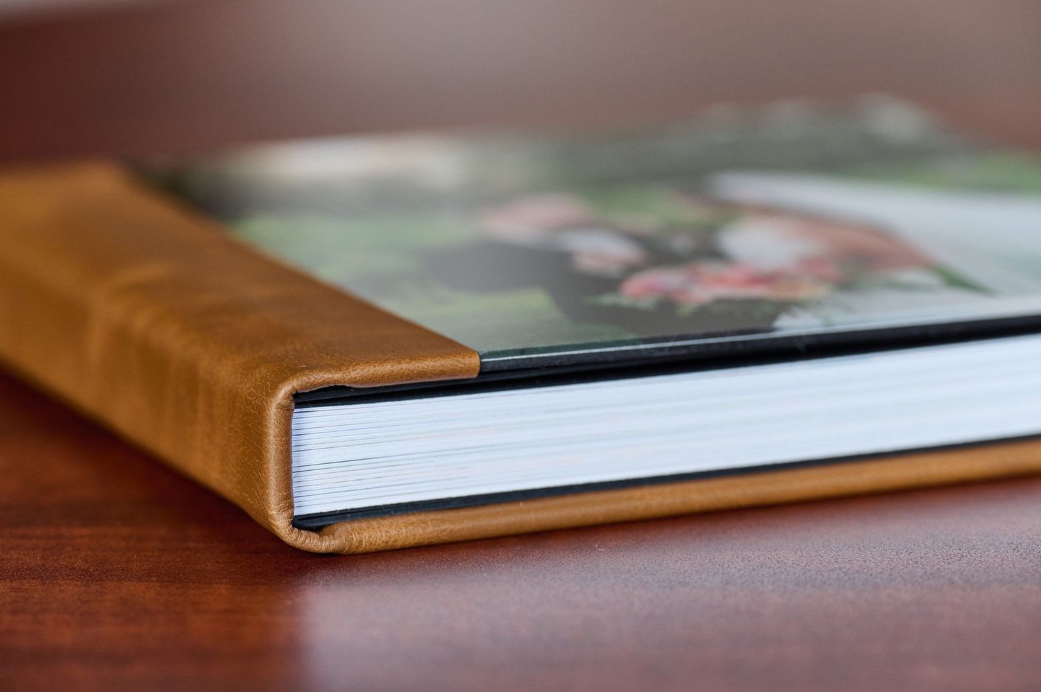 Close-up photo showing the spine and edge of a hardcover book with a glossy dust jacket.