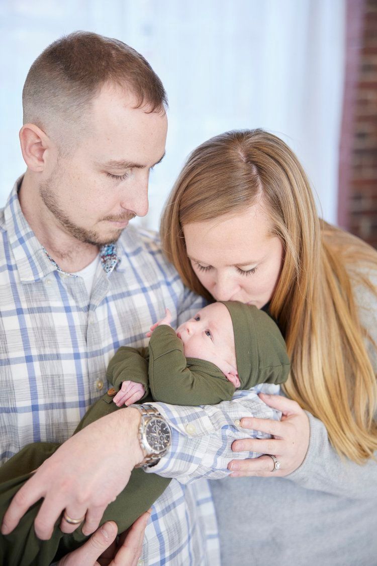A series of tender moments showing a couple holding and kissing their newborn baby in a heartfelt photo collage.