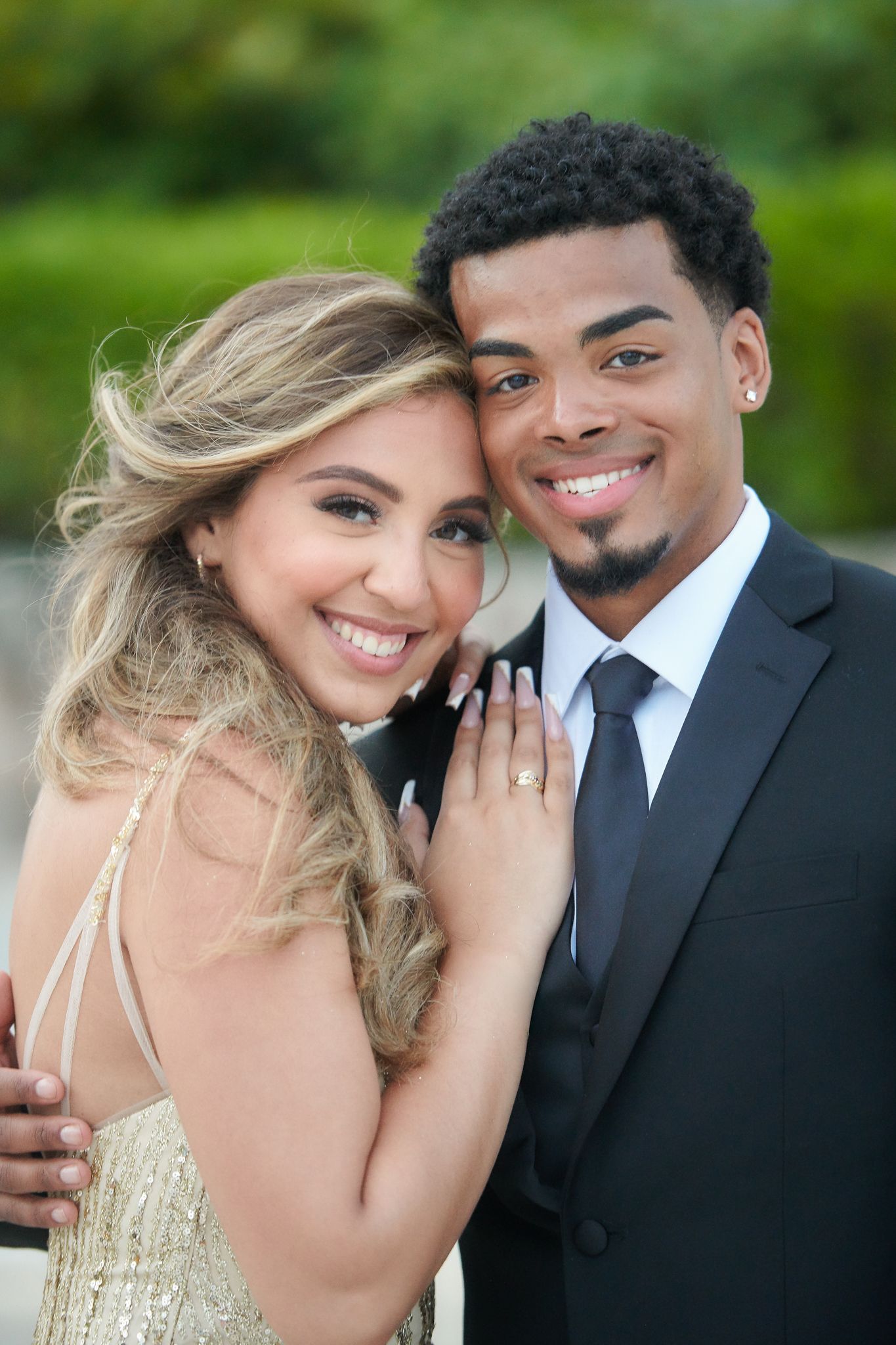 Engagement photo series showing couple laughing and embracing outdoors.