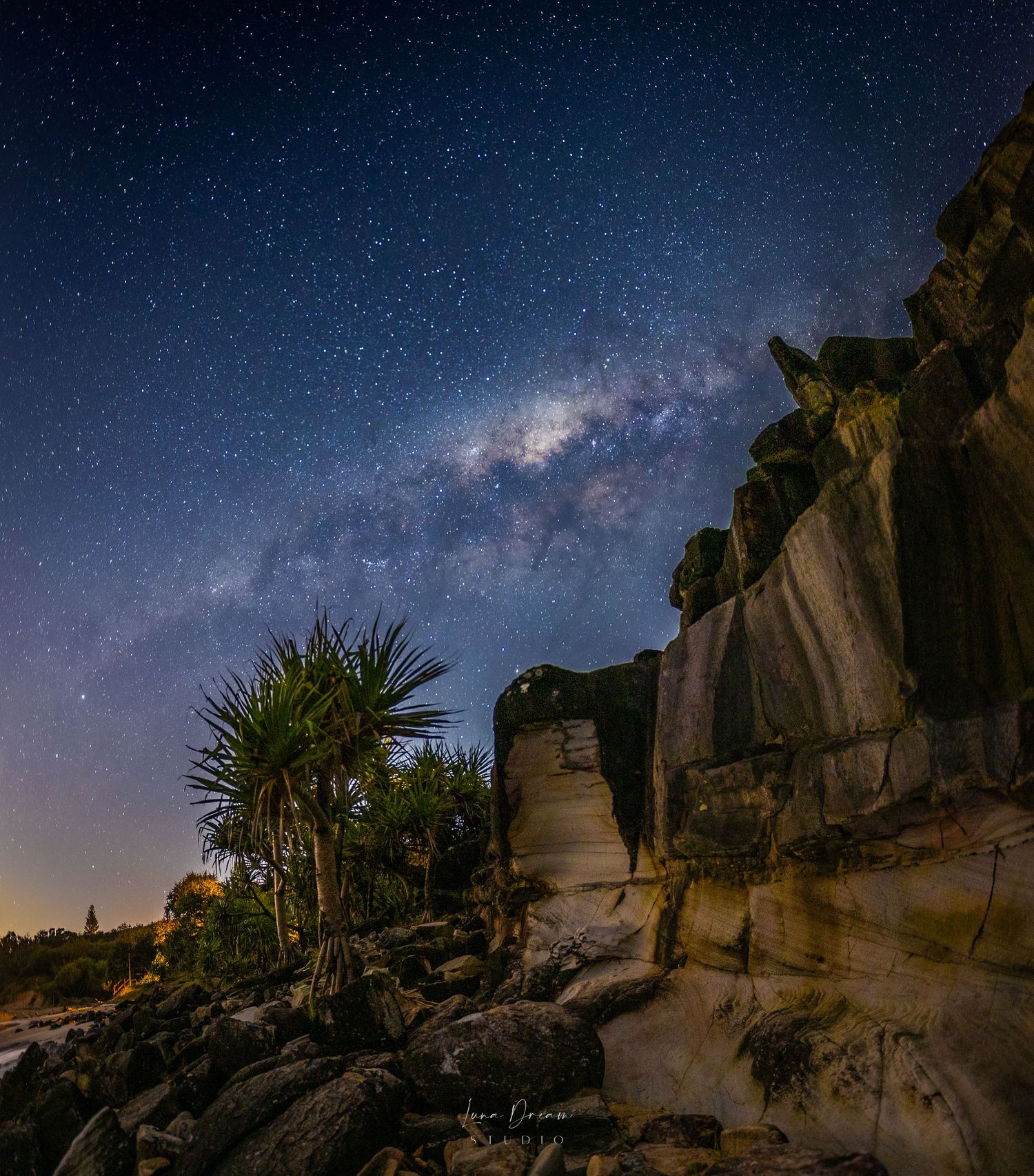 Coolum Beach.Milky Way rising over rocky terrain and desert plants, capturing dramatic nightscape photography and rugged natural landscapes