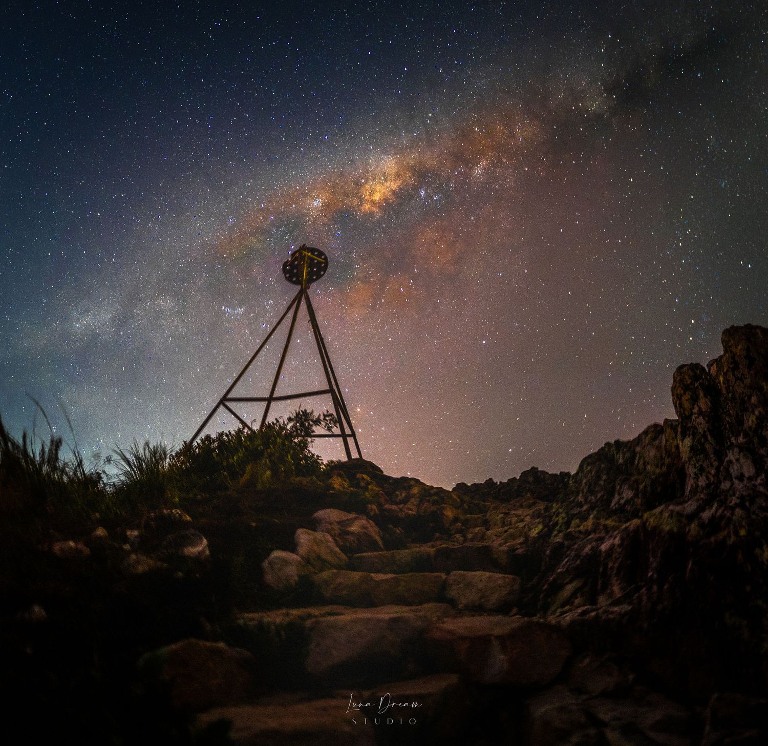 Emu Mountain, Sunshine Coast, Queensland. A glowing Milky Way arch above a mountain trig point, showcasing dramatic nightscape photography.