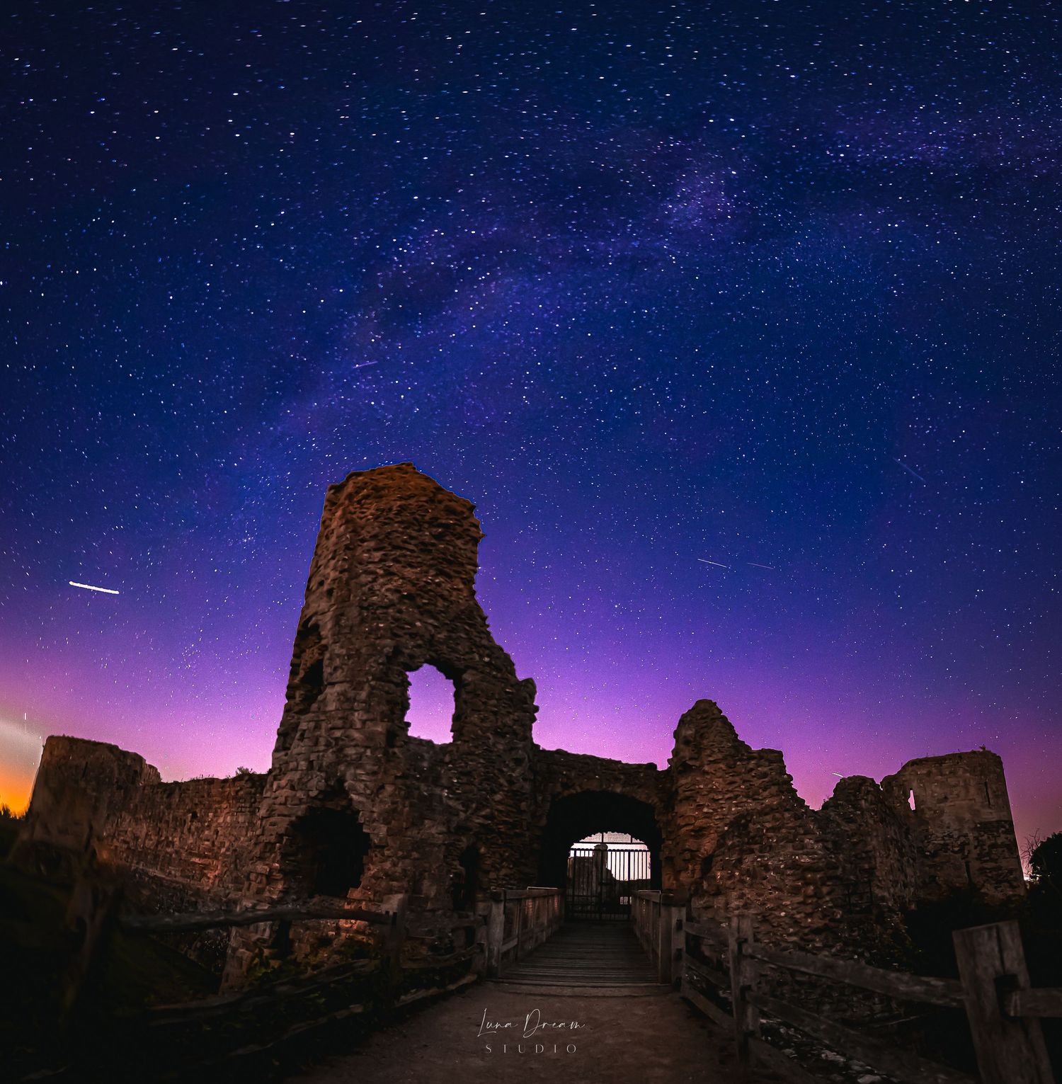Pevense castle beneath a vivid starry sky, featuring dramatic nightscape photo, historic architecture, and enchanting twilight colours