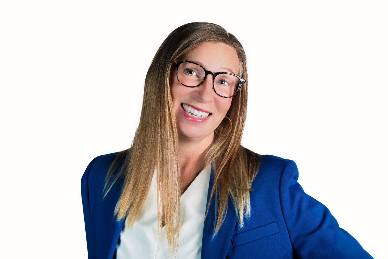 Professional wearing glasses and a bright blue blazer smiles warmly against a white background.