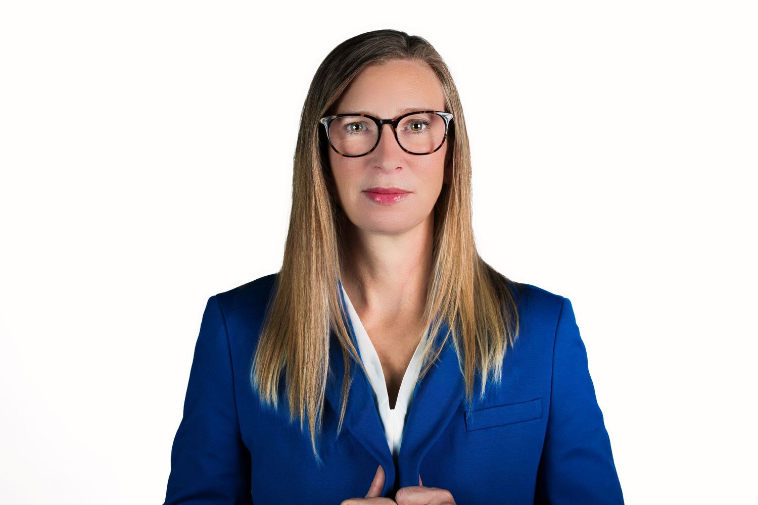 Professional headshot series of a person in a royal blue blazer and glasses against white background.