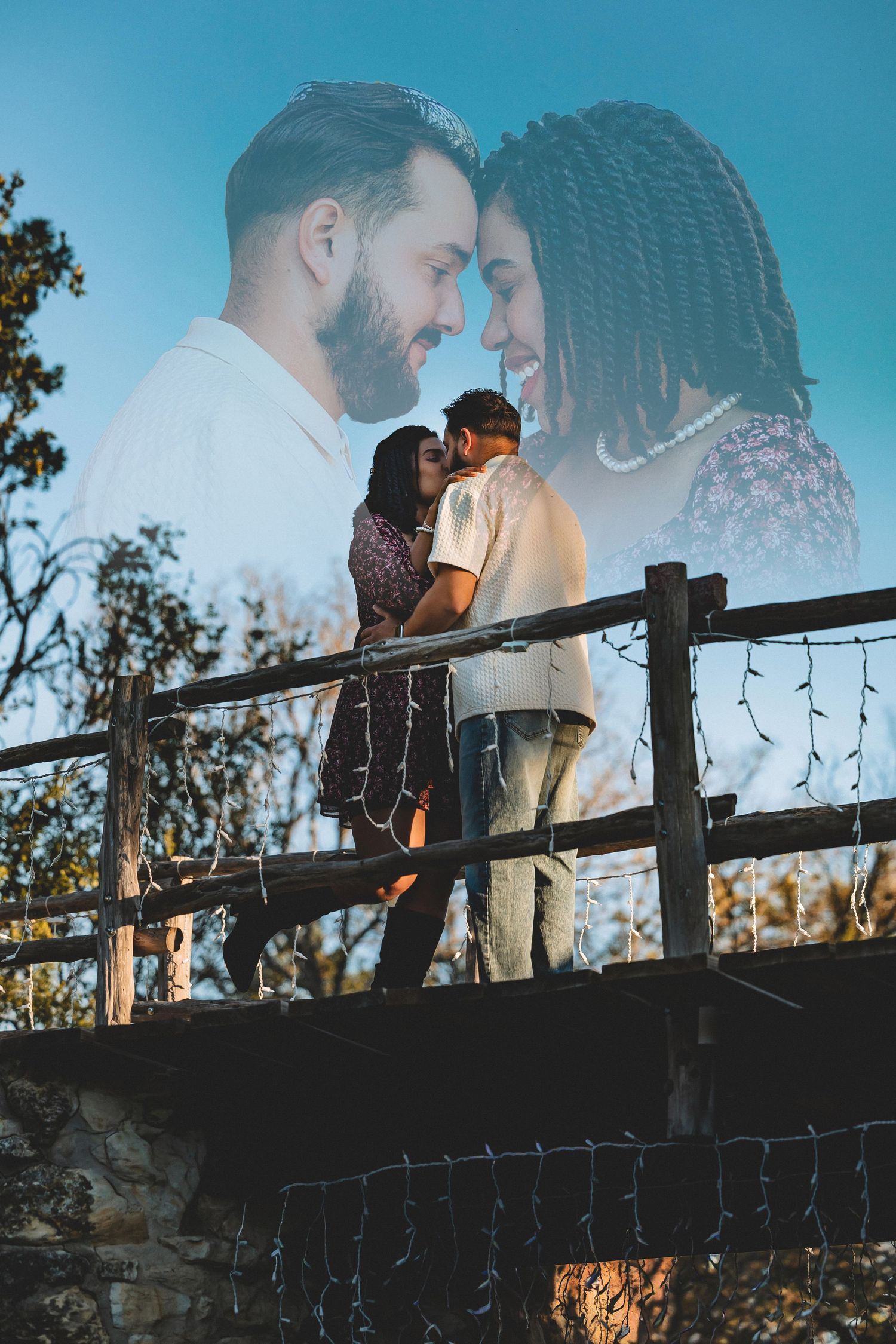 A romantic couple shares an intimate moment at sunset while standing on a rustic wooden bridge.