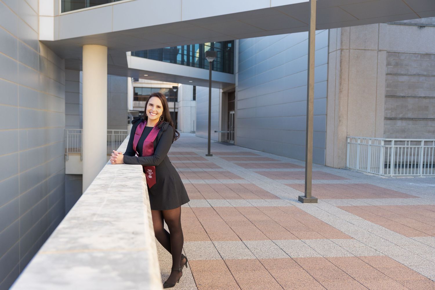 A sequence of photos showing someone walking down a covered outdoor walkway with columns and railing.