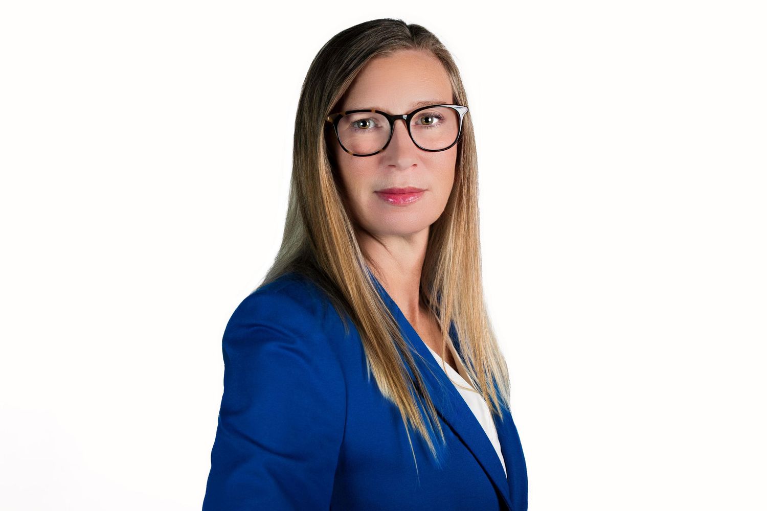 Business portrait of a person in glasses and blue jacket with a friendly expression against white backdrop.