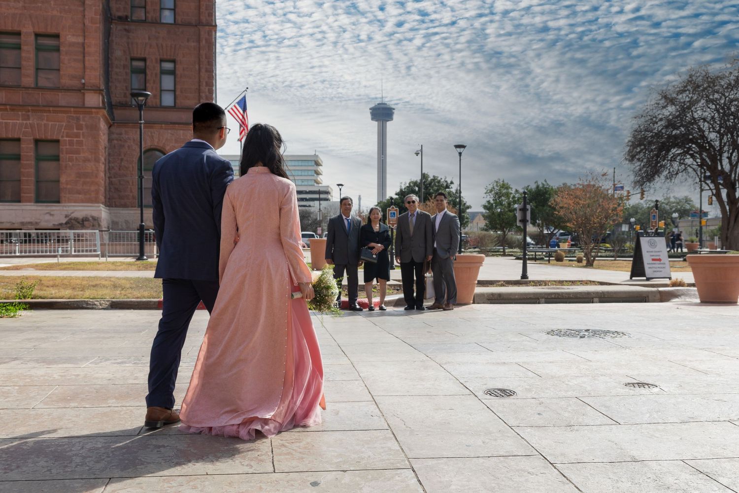 A series of five connected photos showing people on the steps of a historic courthouse building.
