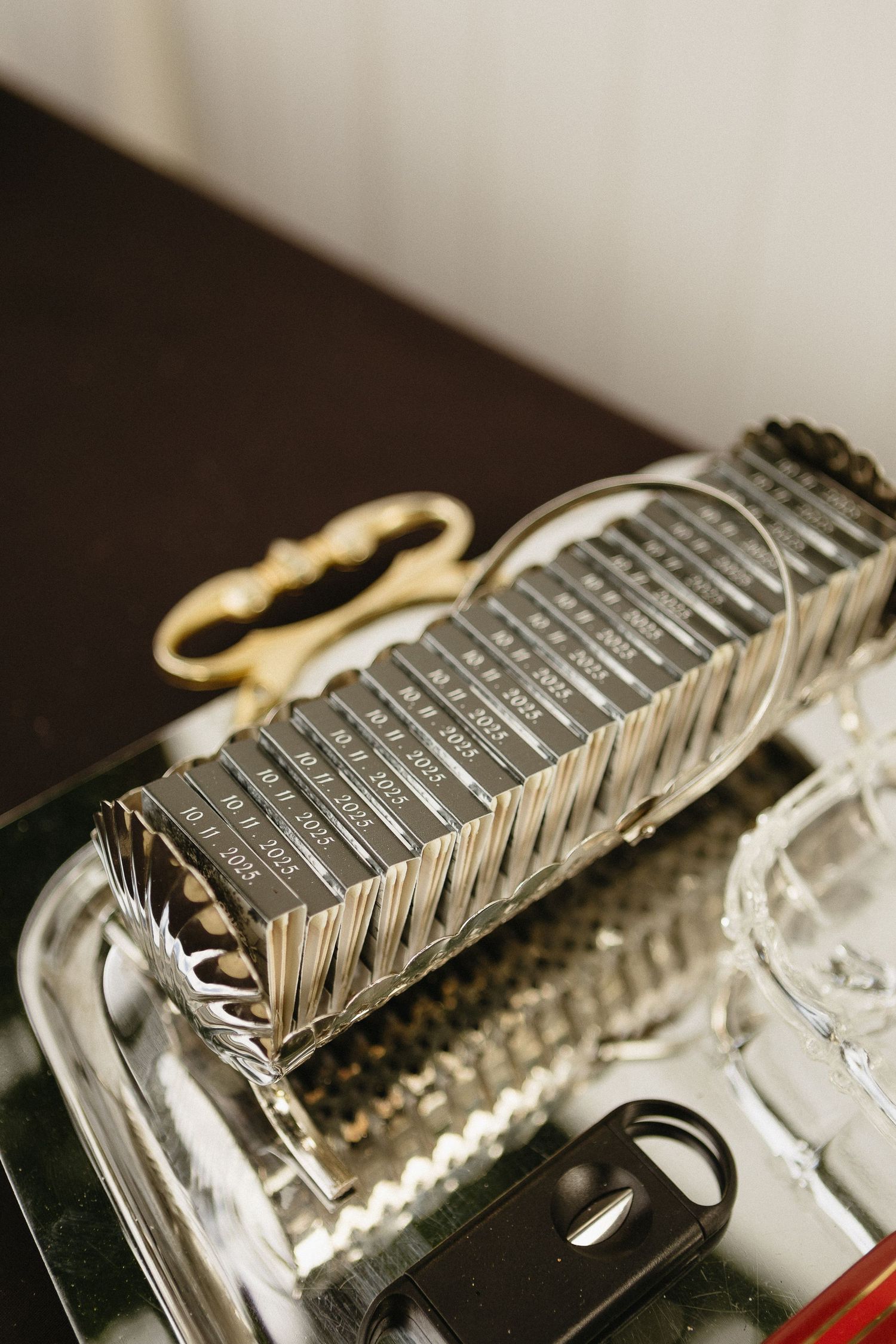 Close-up detail shots of metallic wedding rings on a reflective surface.