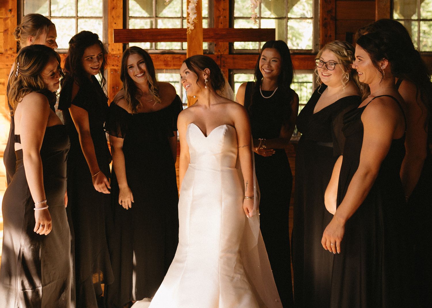 bride smiling at bridesmaids on wedding day