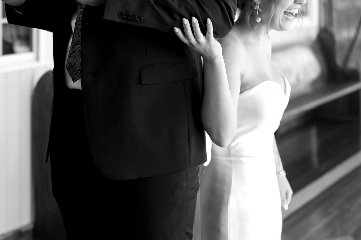 smiling bride and groom reading vows and showing wedding rings