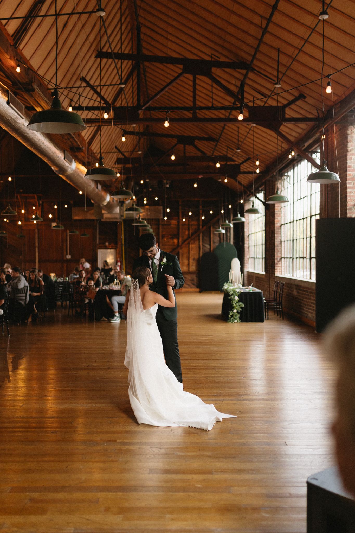 Bride and groom sharing a romantic first dance at an outdoor reception