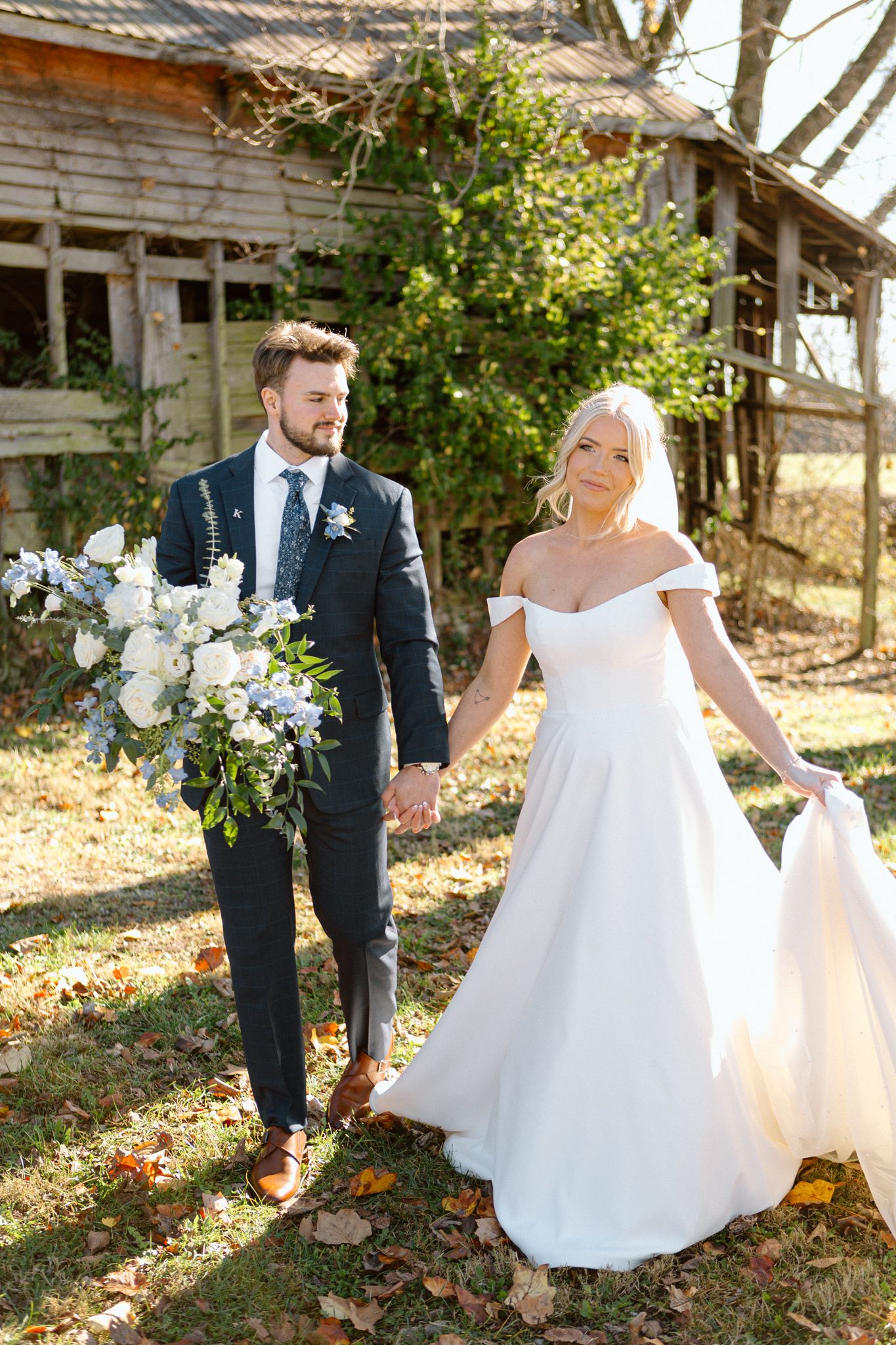 Bride and groom posing with a lush bouquet at Silo Farms. Photo by Joia Lyn, KY wedding photographer