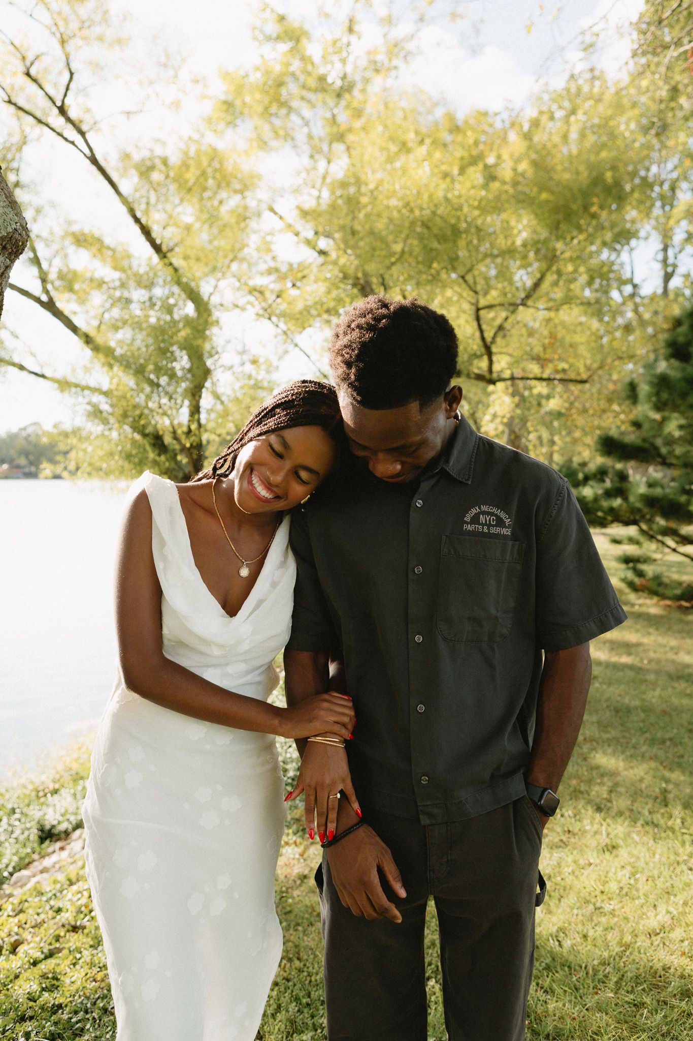 Engaged Black couple sharing a quiet, loving moment under tall trees in Lexington, KY.