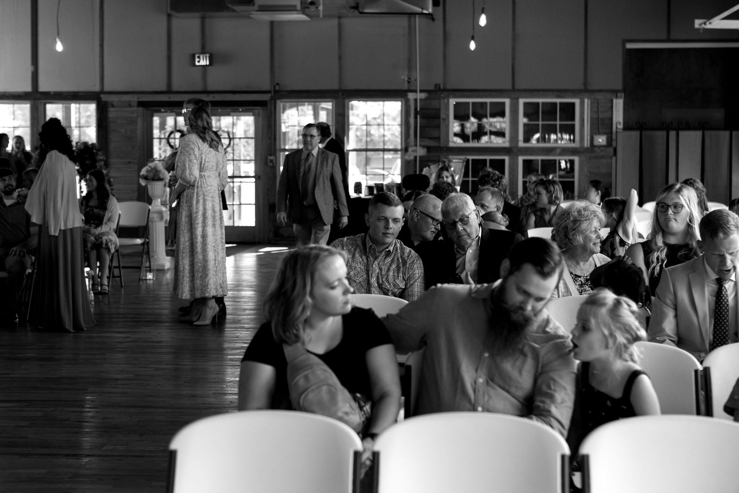 wedding guest arriving to wooden industrial style wedding venue