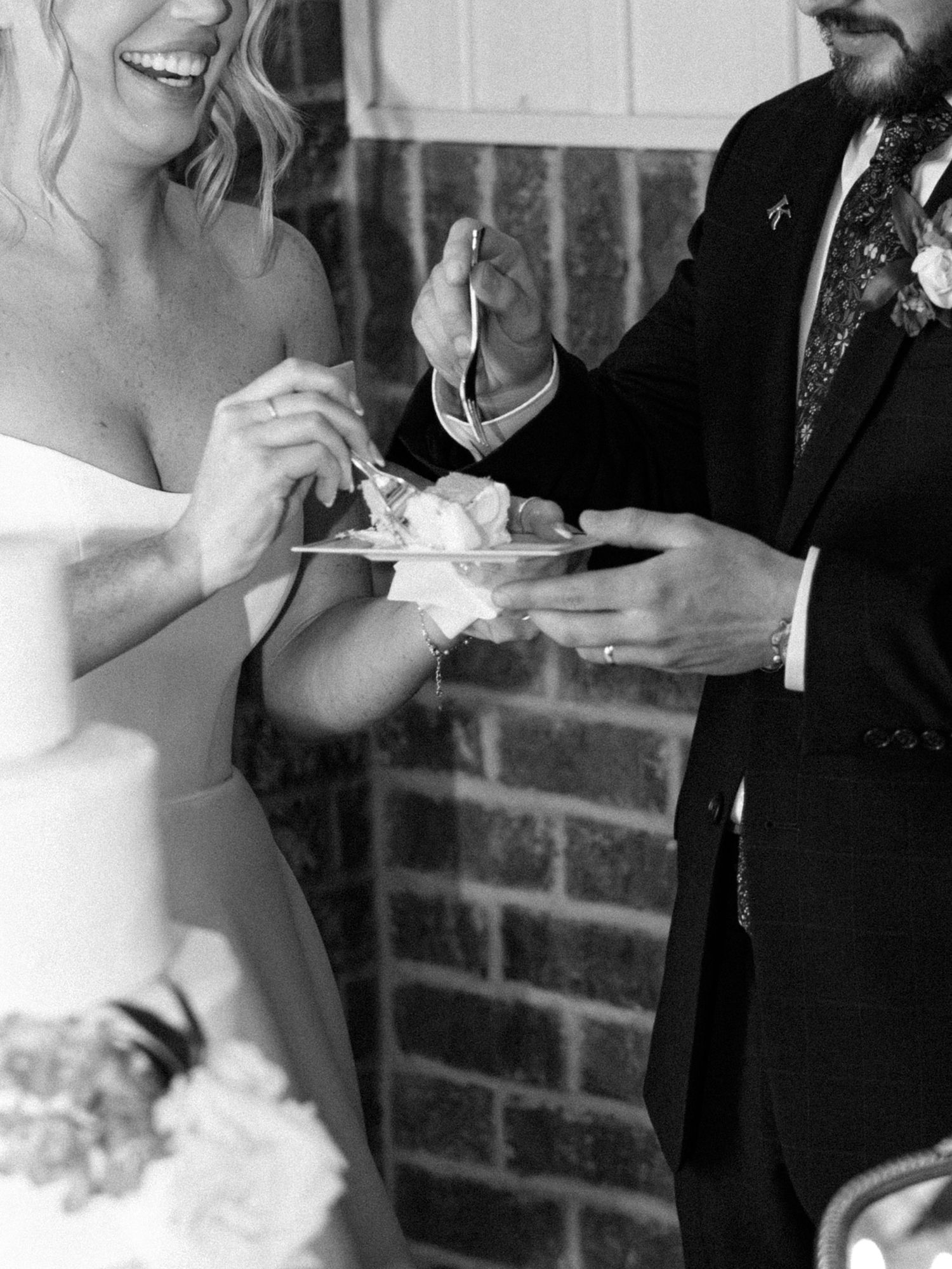 Bride and groom share a joyful wedding cake cutting moment at Silo Farm, captured by Joia Lyn, a Kentucky wedding photog
