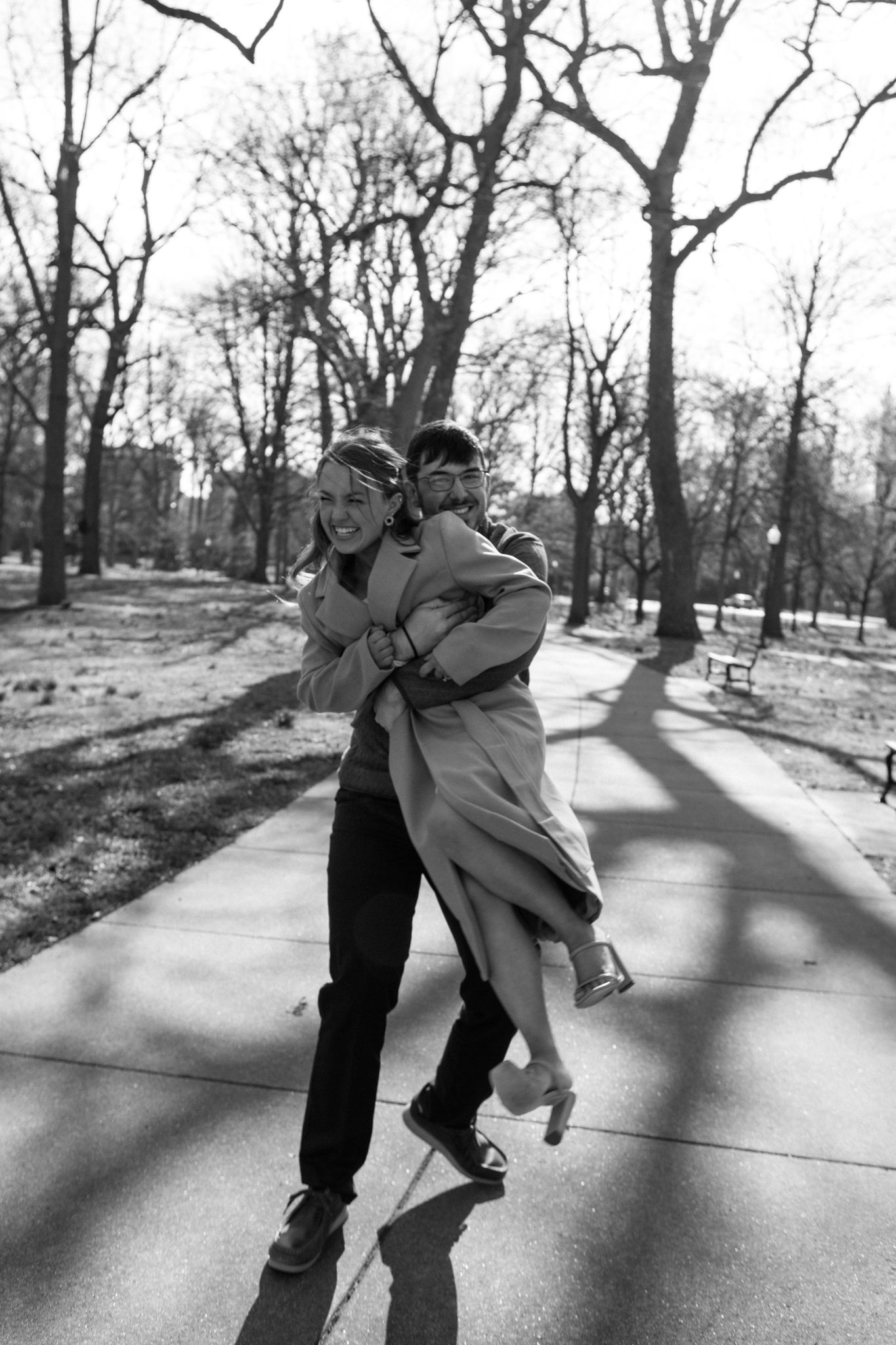 Romantic engagement photo of couple holding hands in Old Louisville's picturesque streets on a cold day