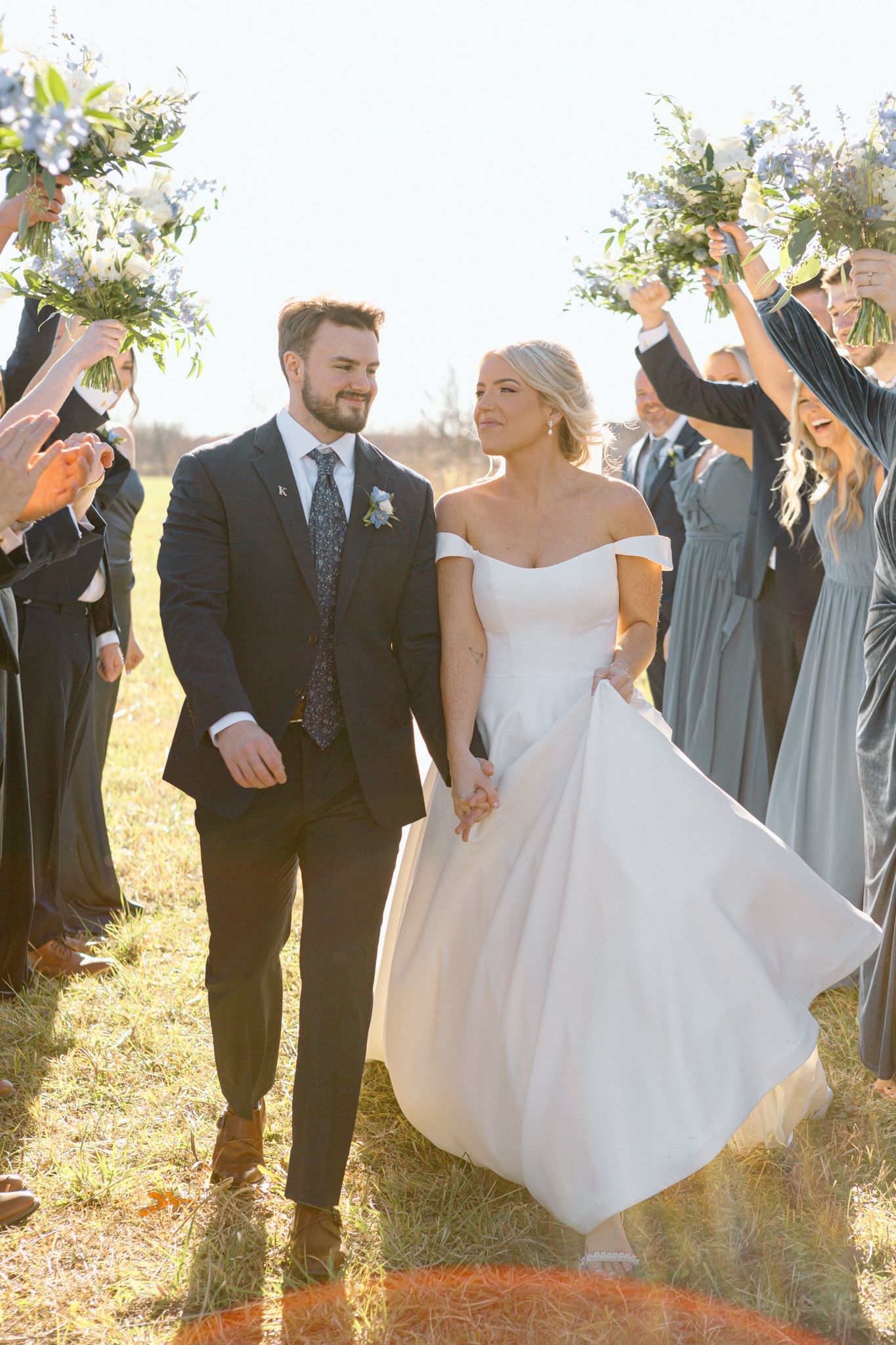 Bride and groom posing with a lush bouquet against a rustic backdrop at Silo Farms. Photo by Joia Lyn, KY wedding photog