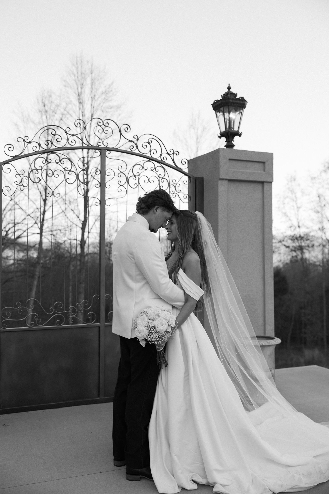 Black and white artistic wedding photos showing romantic intimate moments between newlyweds on an outdoor terrace.