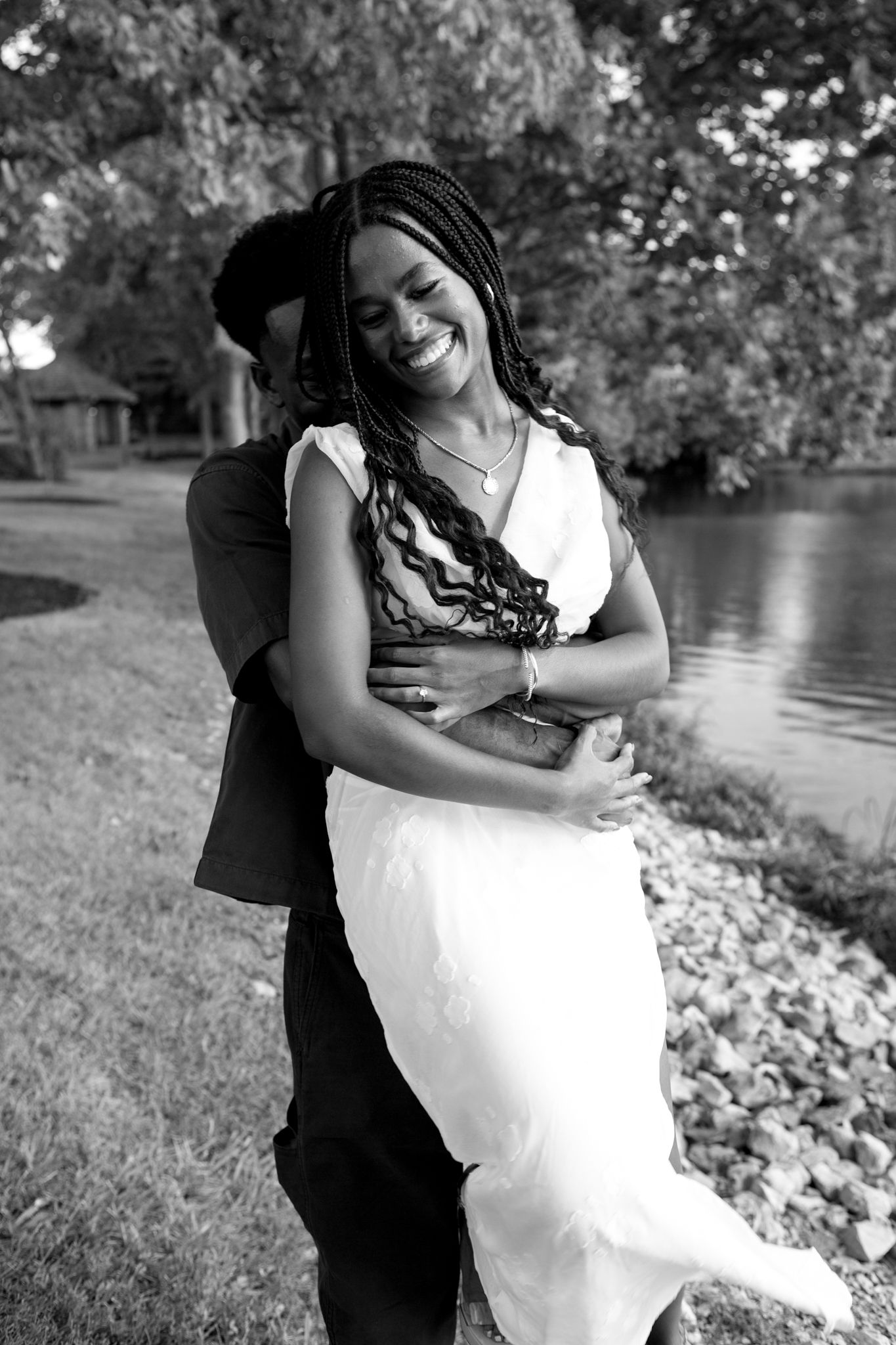 Newly engaged couple, Belle and Chadrack, holding hands and smiling during their proposal photoshoot in Kentucky.