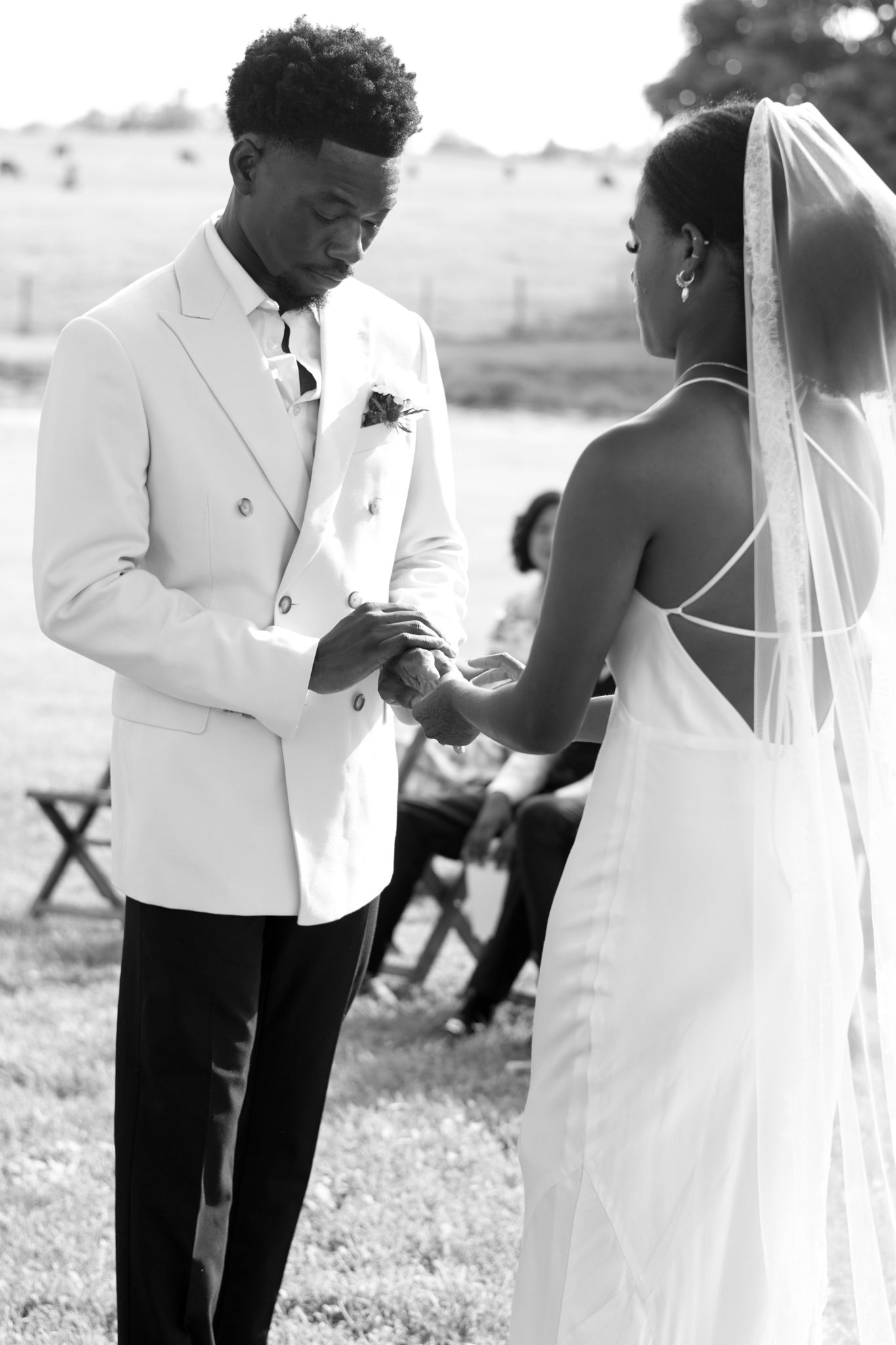 Intimate black and white wedding photography capturing romantic moments between newlyweds in formal attire.