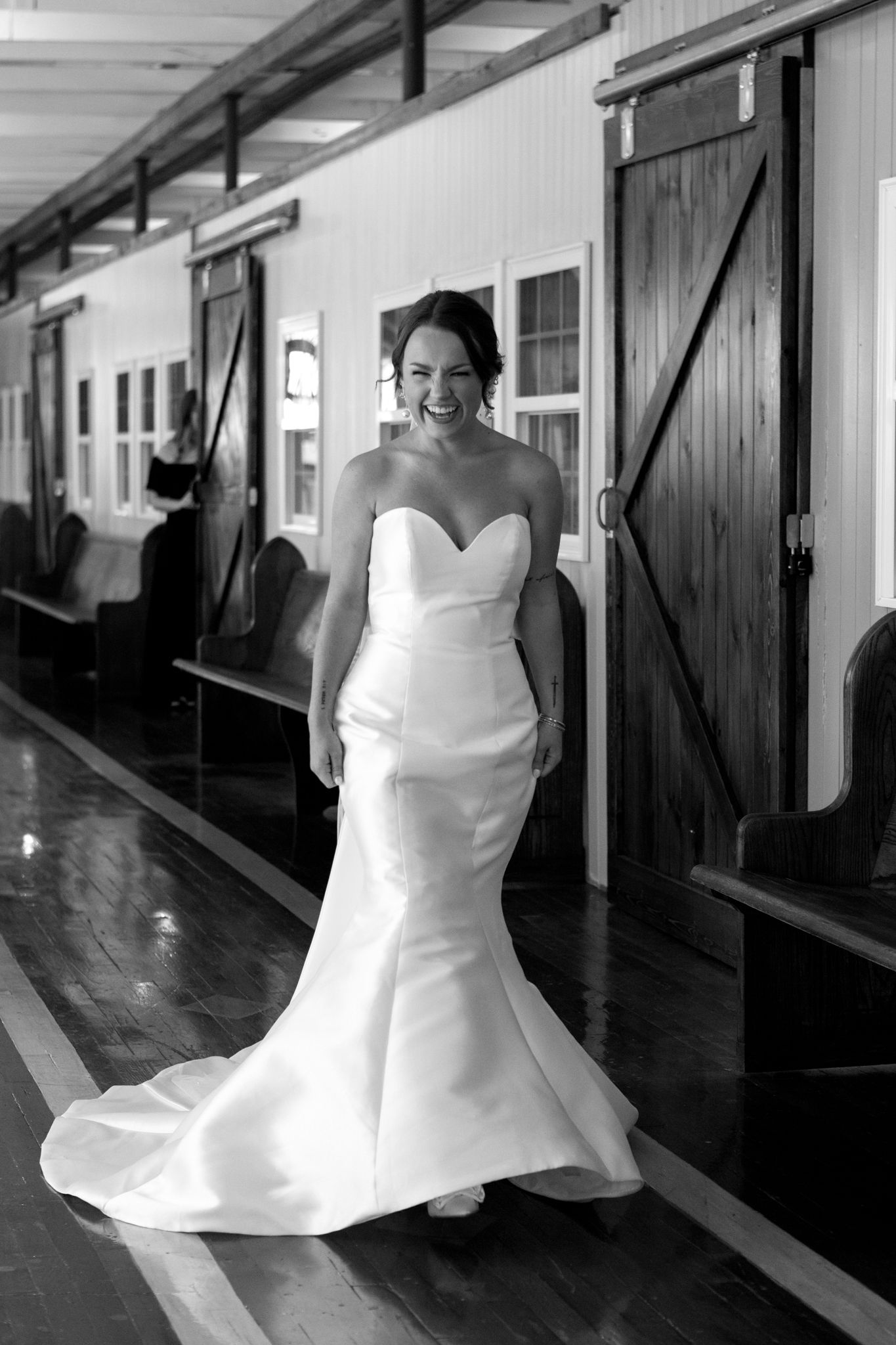 A bride gracefully walks down the hall in her stunning white dress, radiating joy and elegance on her special day