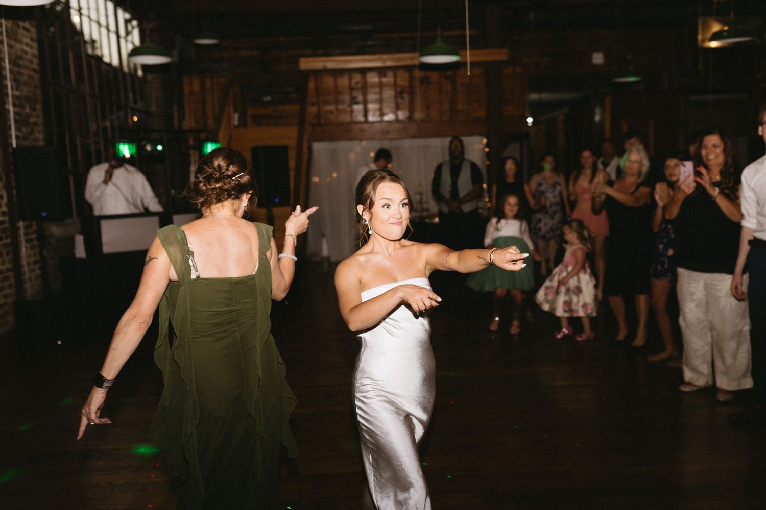 Fun-filled wedding reception with guests dancing to live music.