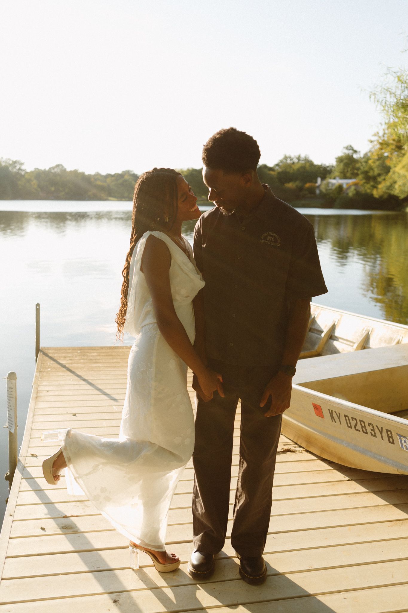 Romantic proposal at a lakeside location in Lexington, Kentucky, with a young Black couple.